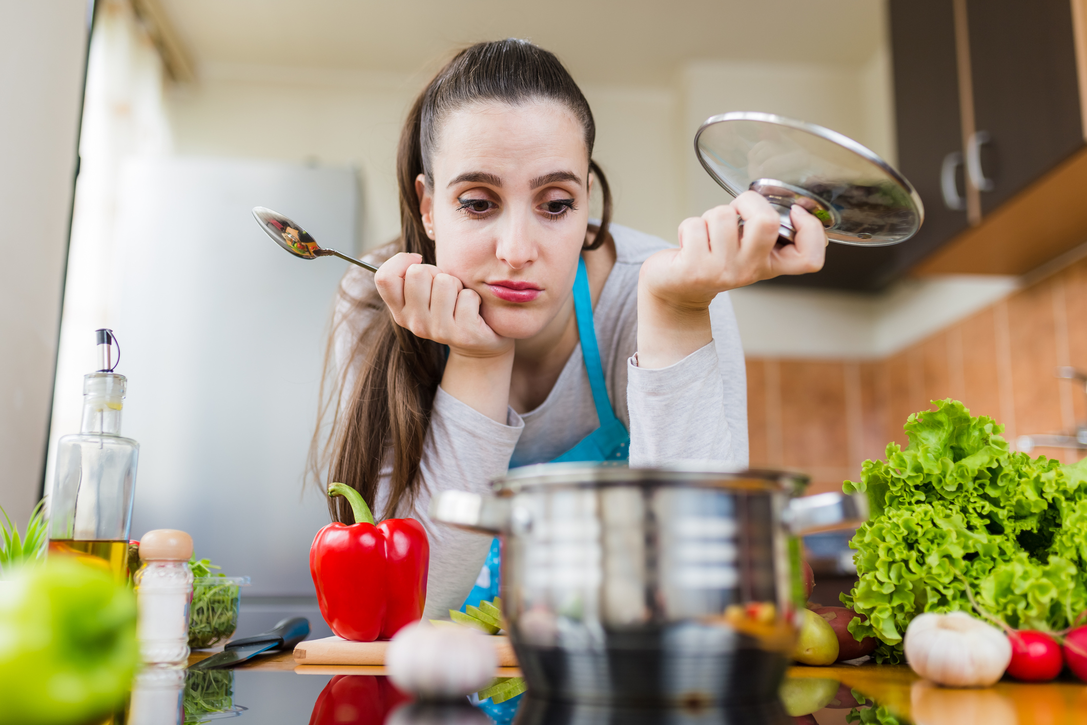 Dissatisfied housewife trying to prepare healthy meal. Cooking learning problems.