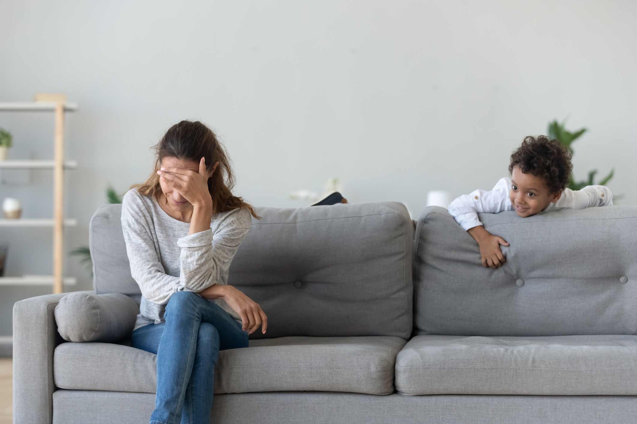 Upset woman suffering from haughty African American boy bad behavior