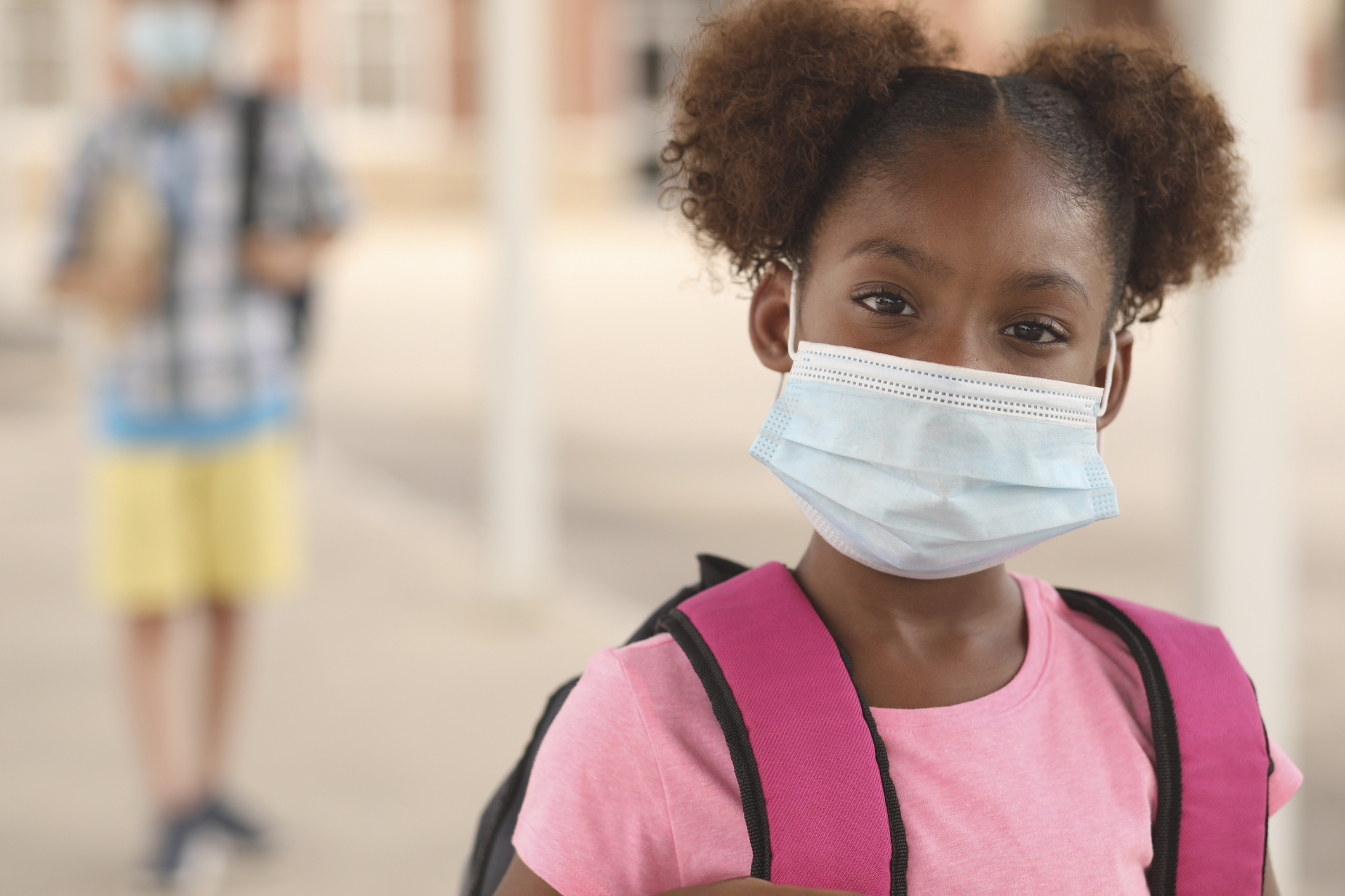 African descent, girl on school campus. Mask for COVID-19.