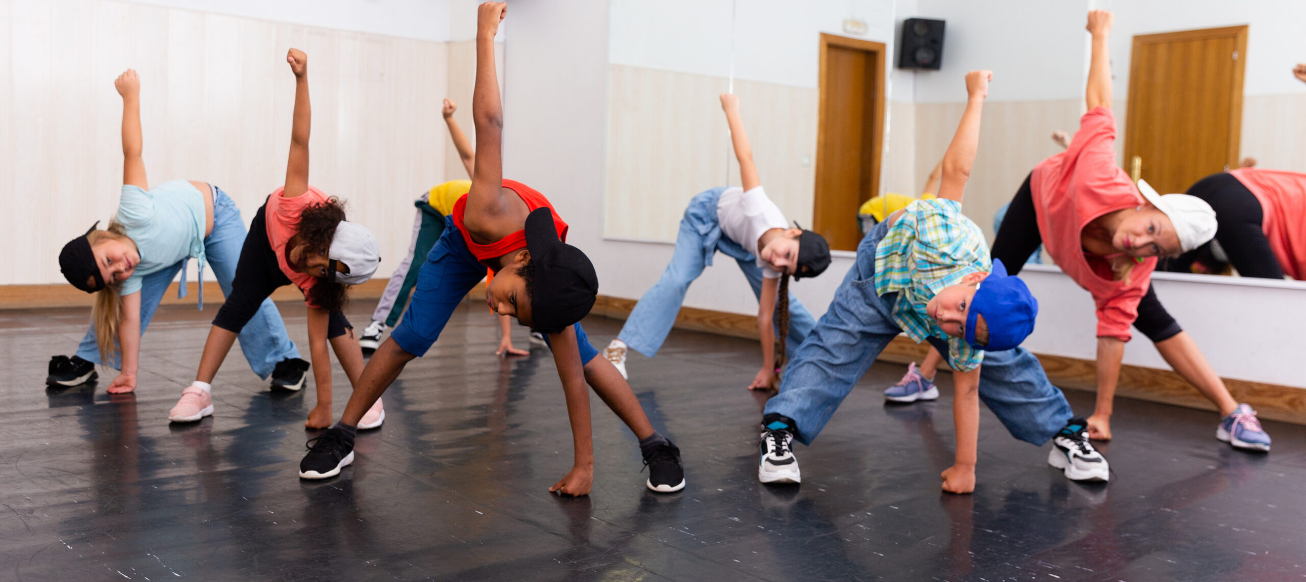 Happy tweens practicing hip hop in dance studio