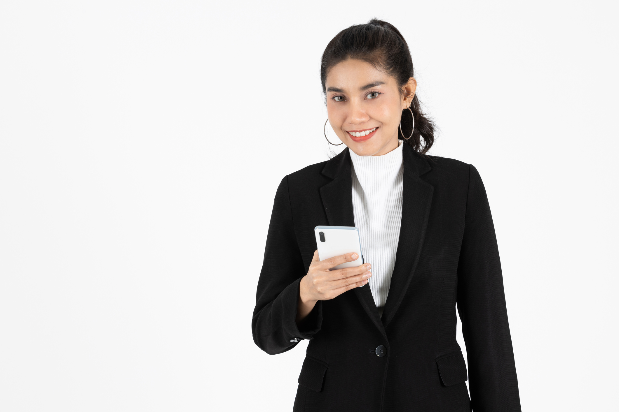 Beauty confident young Asian business woman holding mobile smart phone over white isolated background. Social network, Internet Of Things concept.