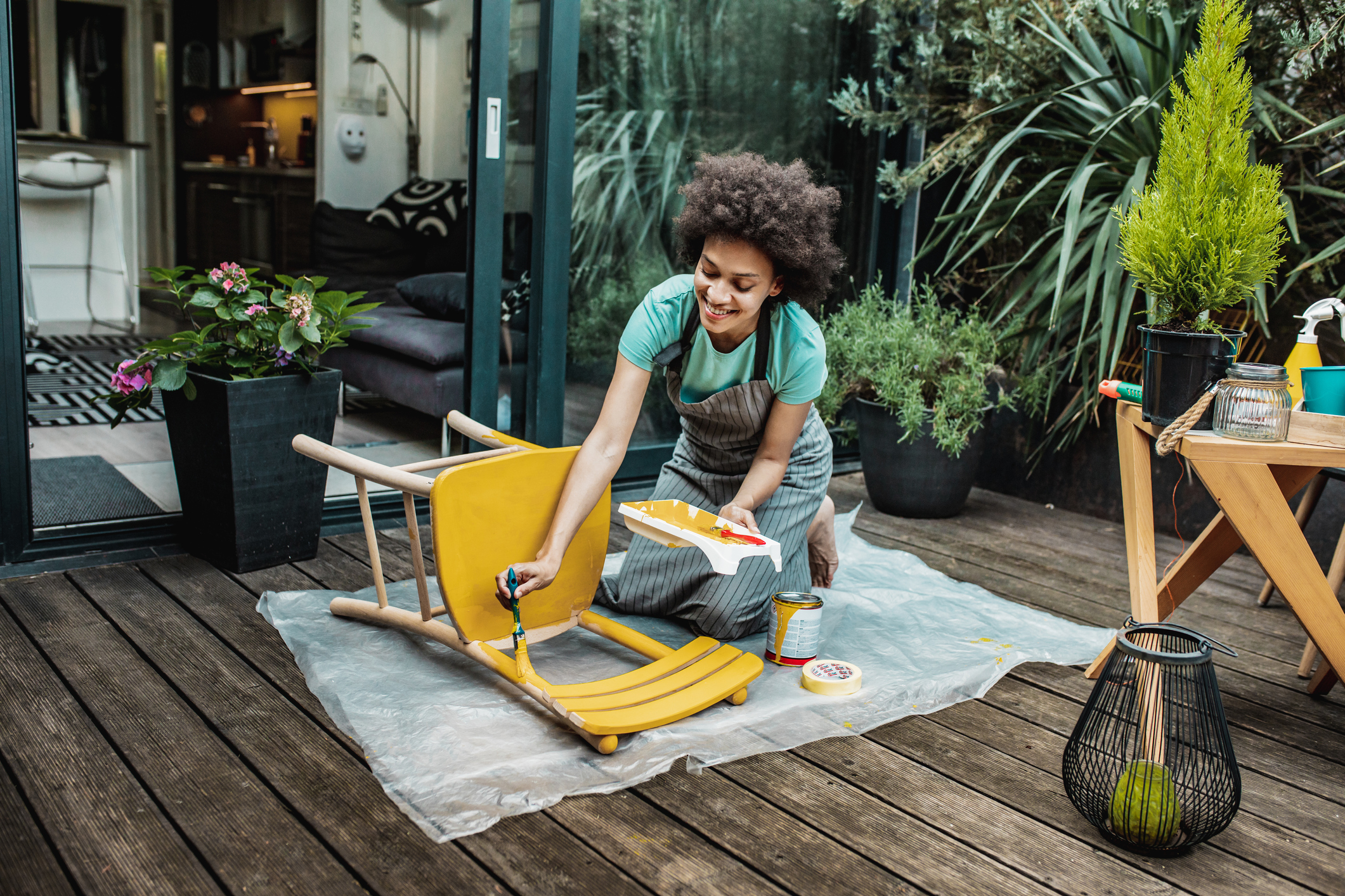 Woman is coloring a chair at home