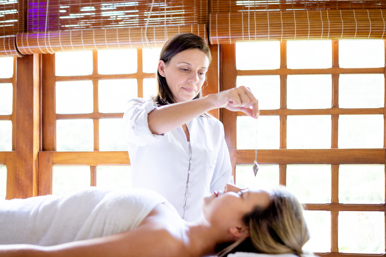 Therapist using pendulum to make diagnosis