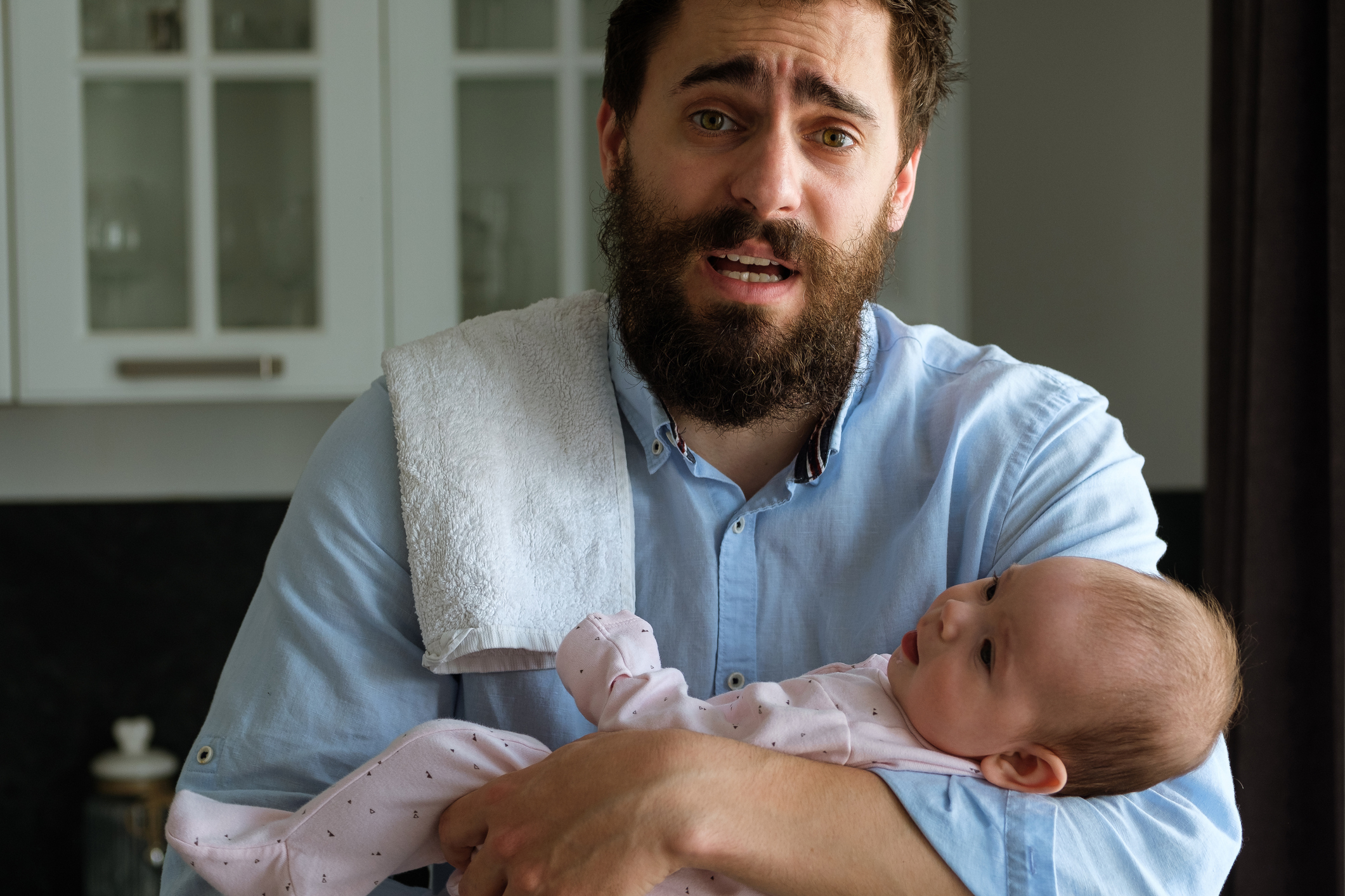 Father in his arms holds his little child