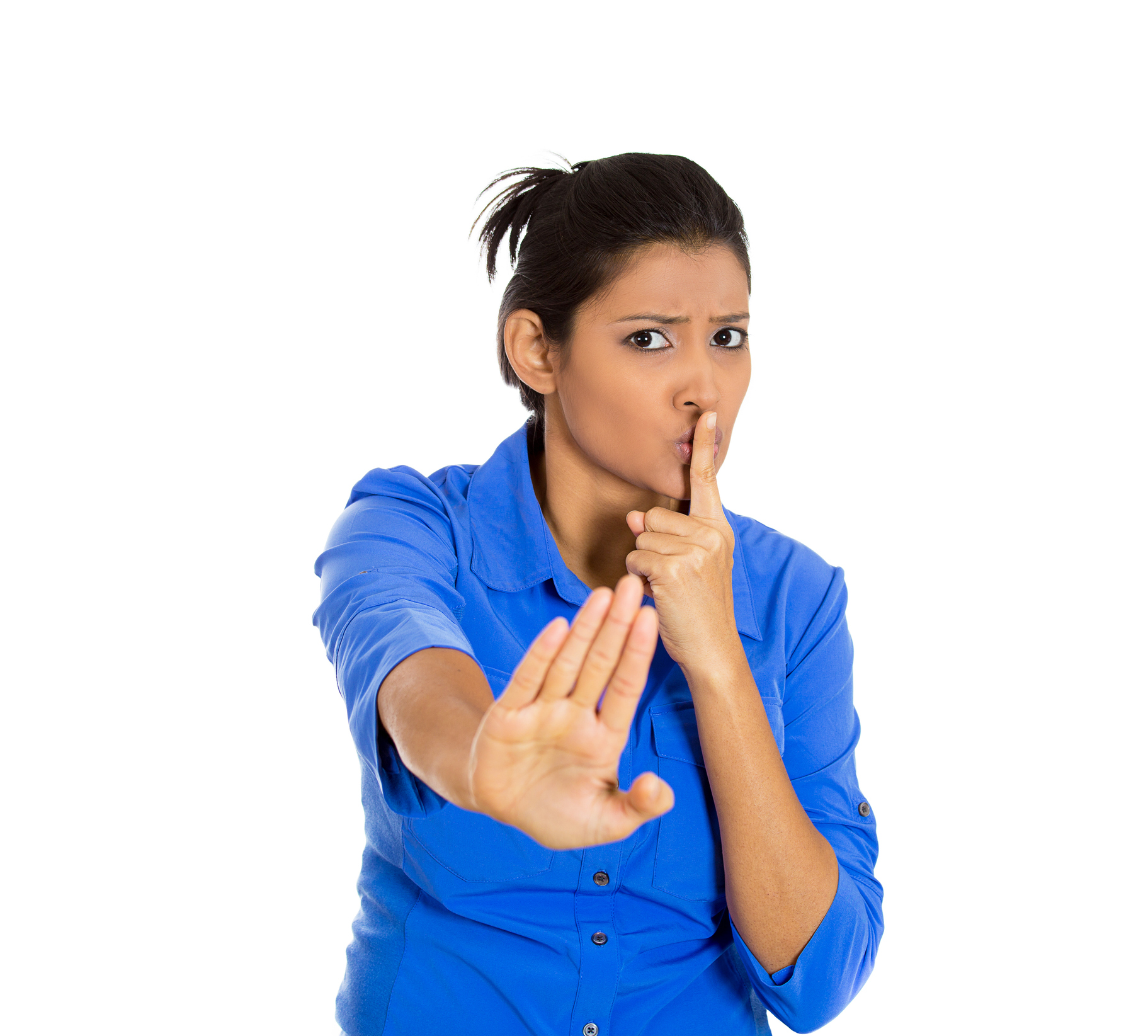 serious woman placing finger on lips, pointing at you quiet, silence