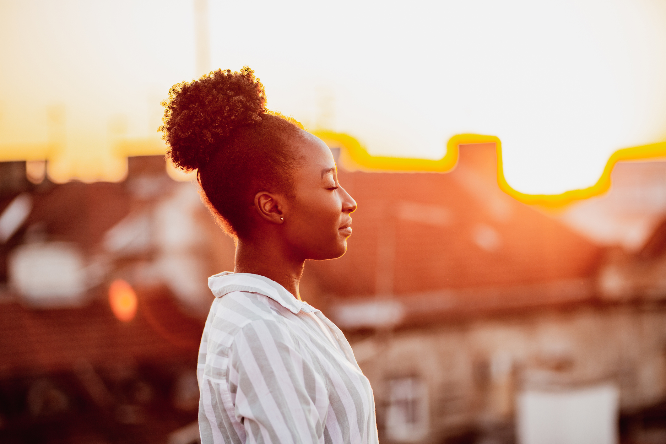 Young African American woman is relaxing on the rooftop