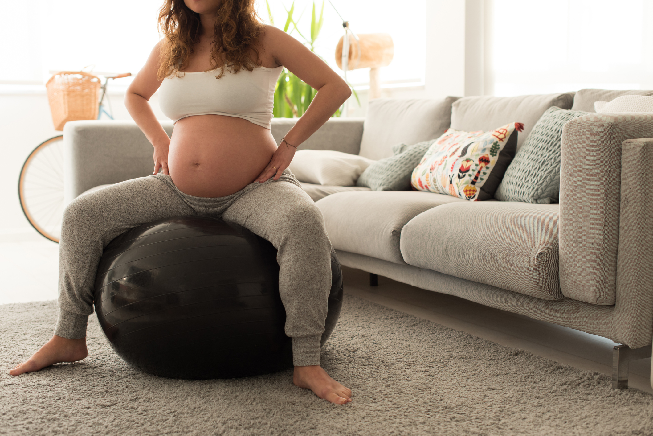 Pregnant woman doing relax exercises with a fitball