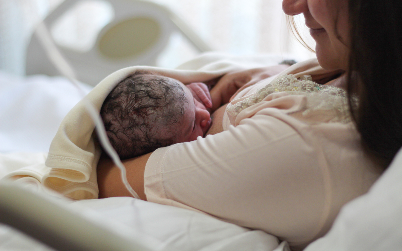 Newborn baby with mother, breastfeeding