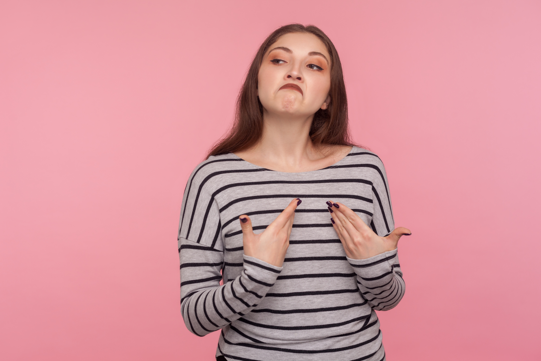 I'm the best! Portrait of arrogant egoistic woman in striped sweatshirt pointing herself and looking supercilious selfish