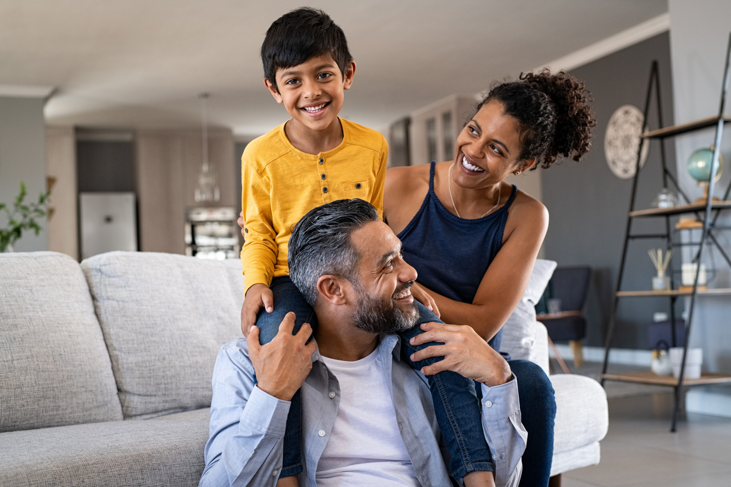 Happy ethnic family playing together at home