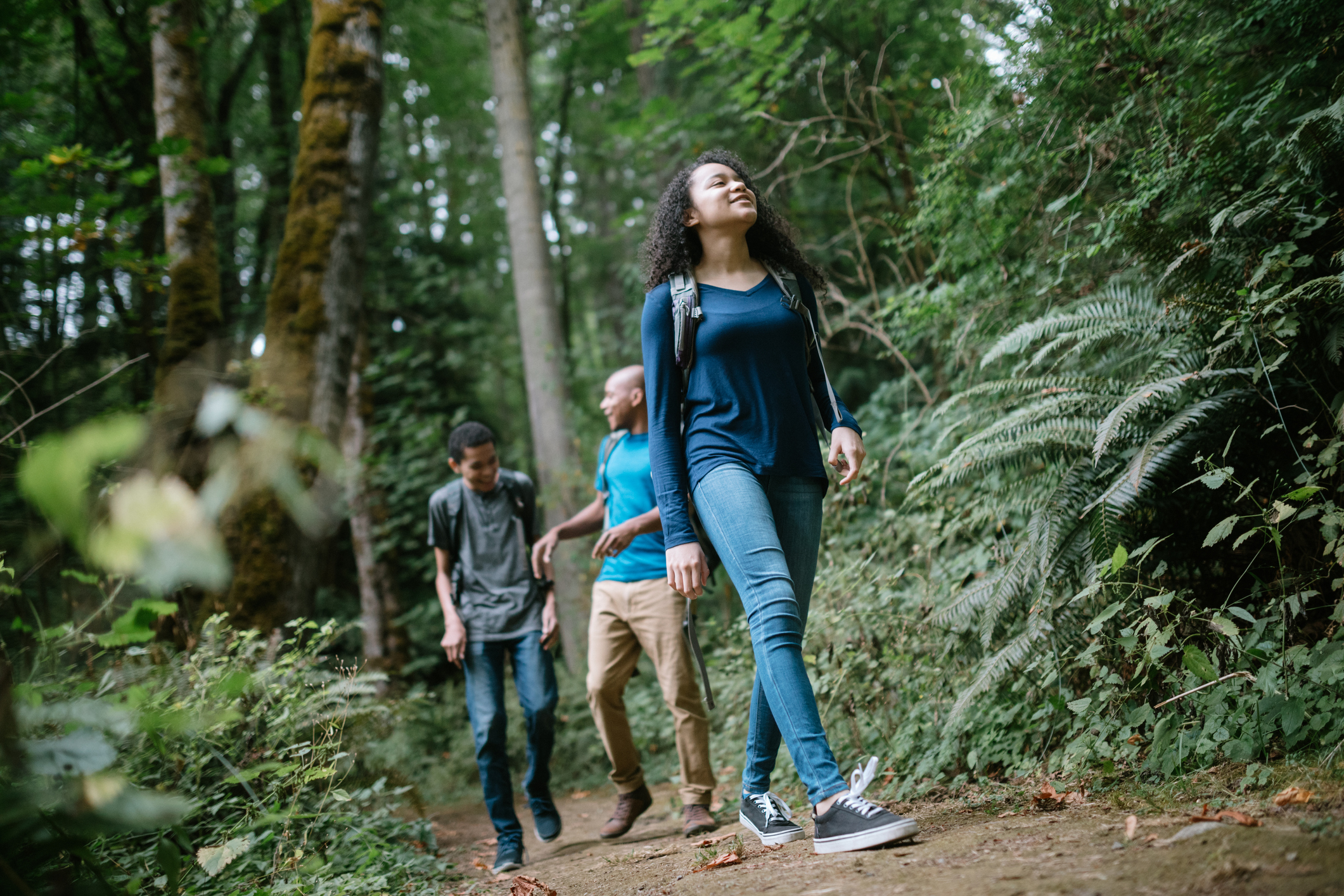 Family Enjoying Hike On Forest Trail in Pacific Northwest