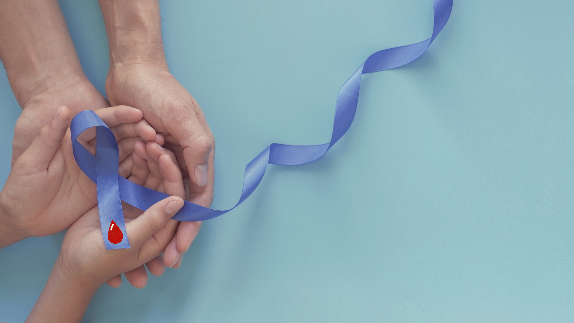 adult and child hands holding Blue ribbon with red blood, world diabetes day