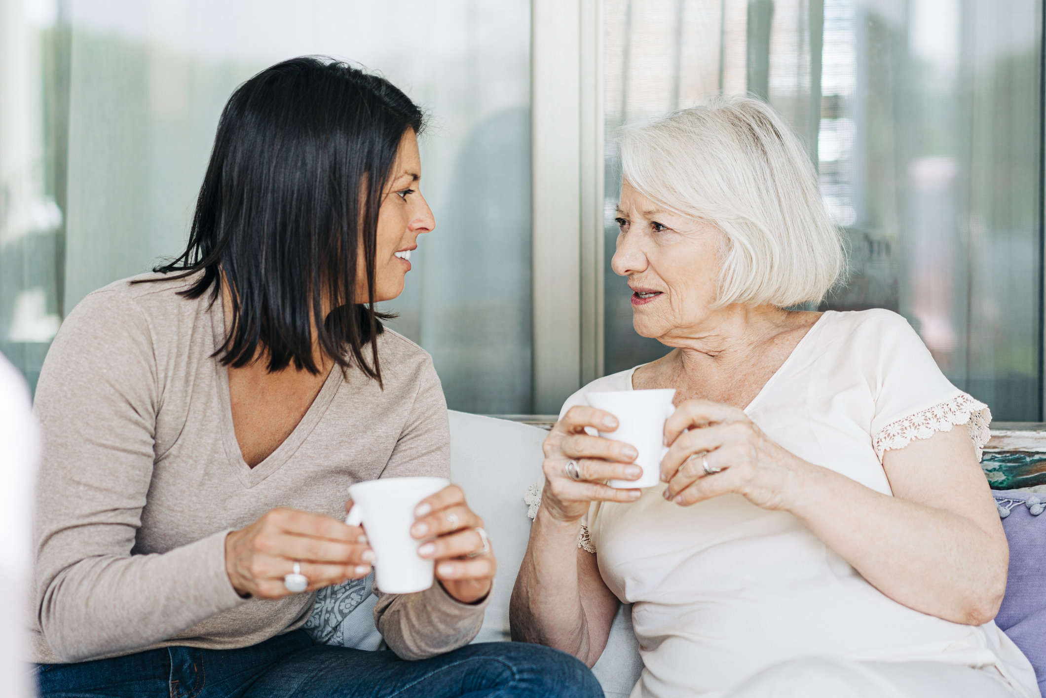 Women talking while having coffee at patio