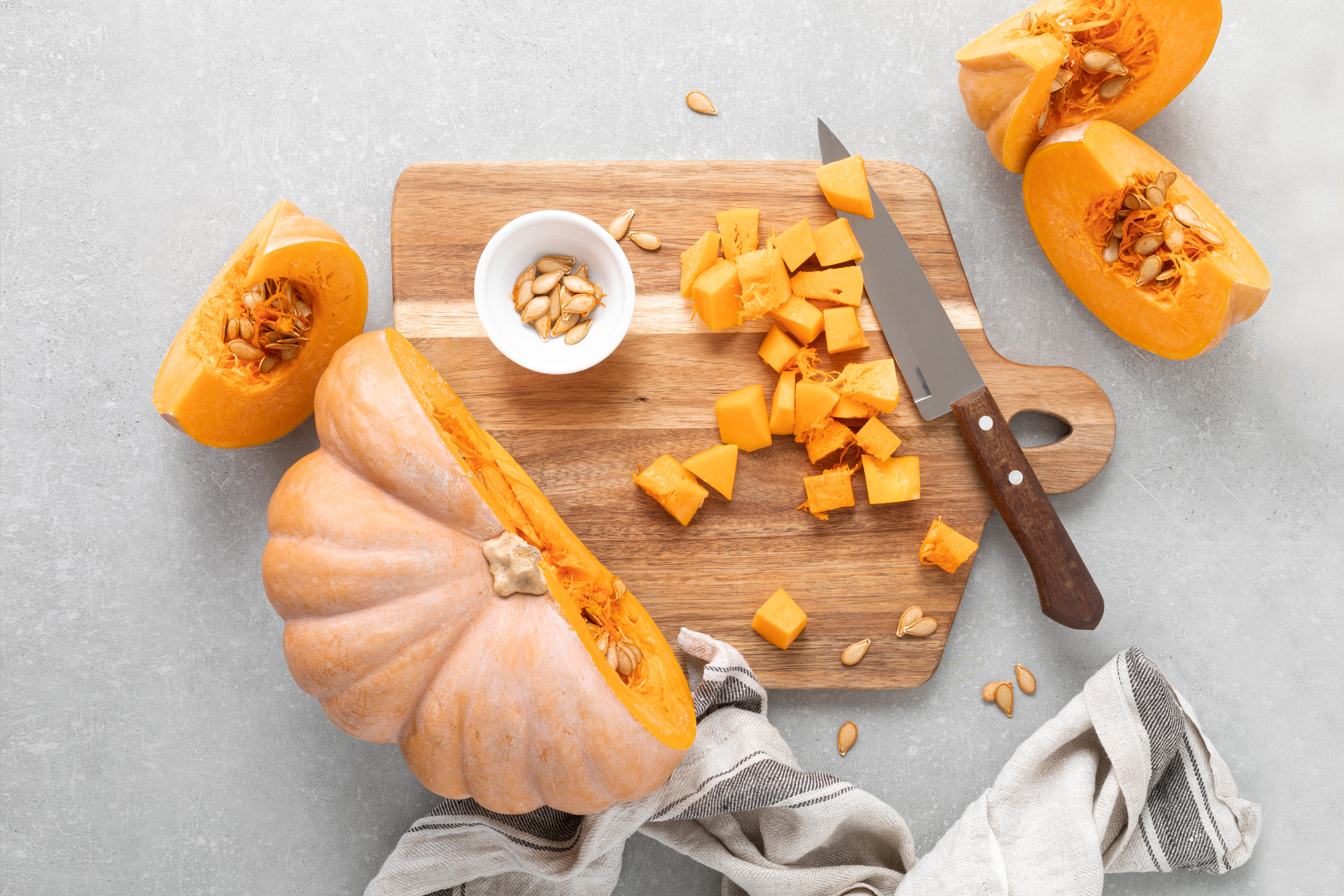 Fresh raw sliced butternut squash on wooden board, top down view