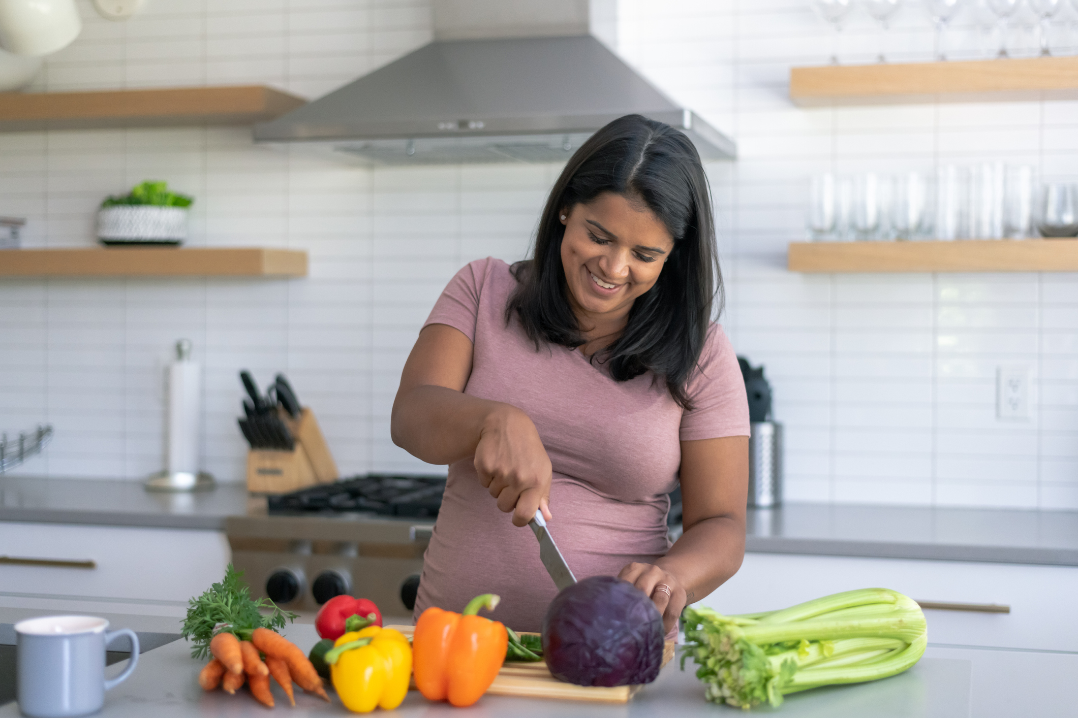 Ethnic Pregnant Woman Cooking In The Kitchen