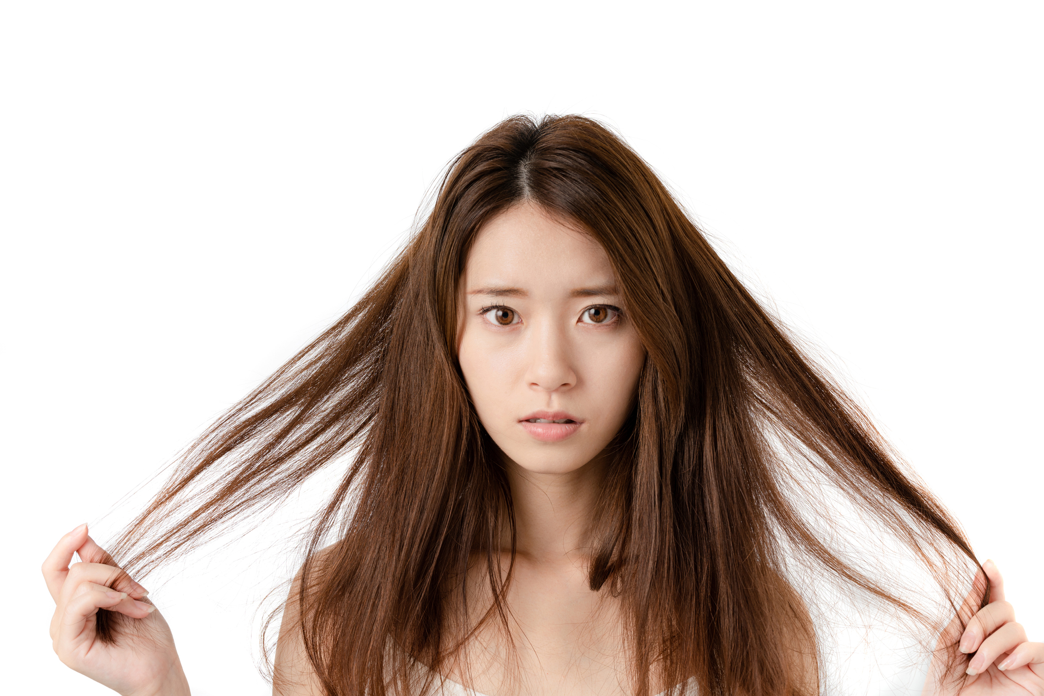 Young woman who be troubled by split ends. damaged hair. beauty and hair care concept.