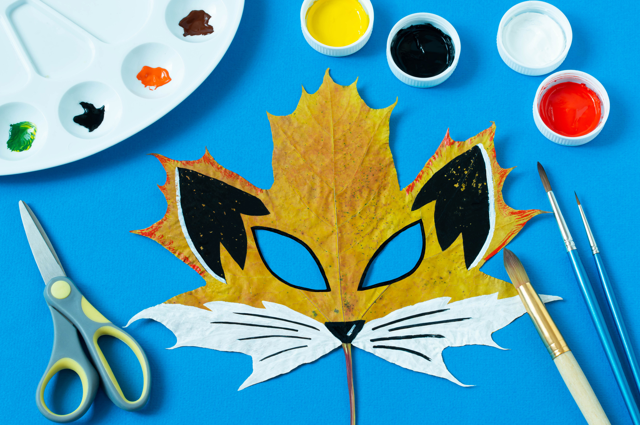 Fox mask painted on maple leaf