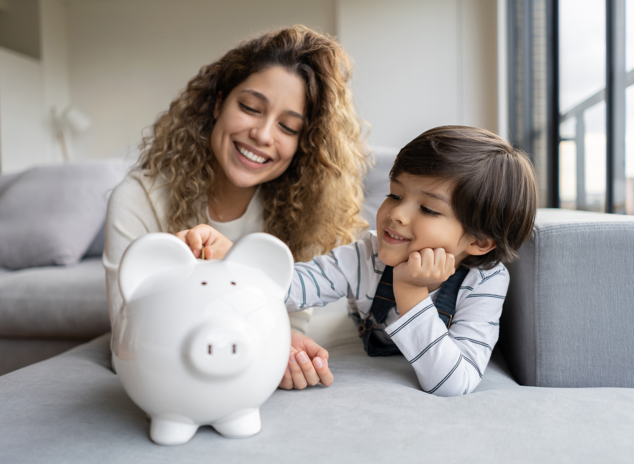 Happy family saving money in a piggybank