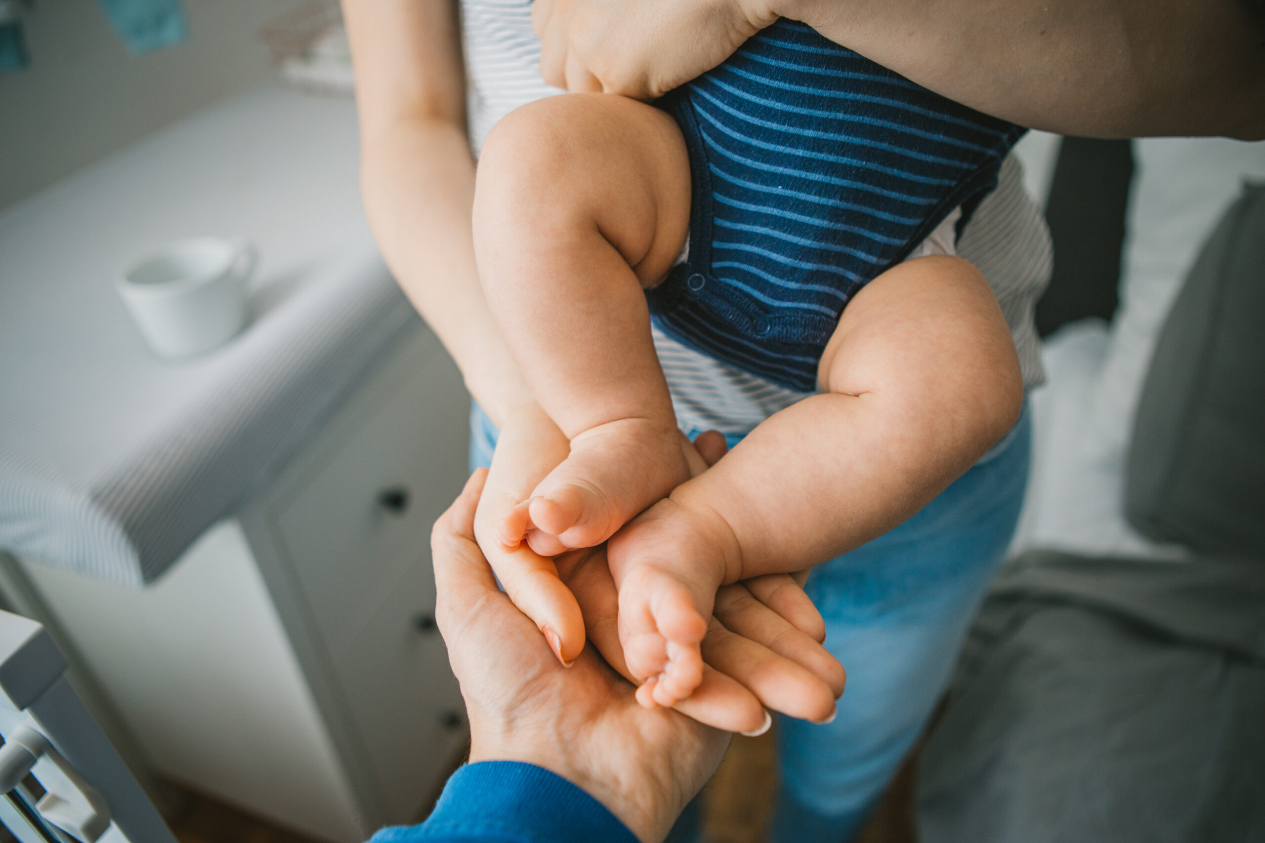 Little baby feet in parents hands
