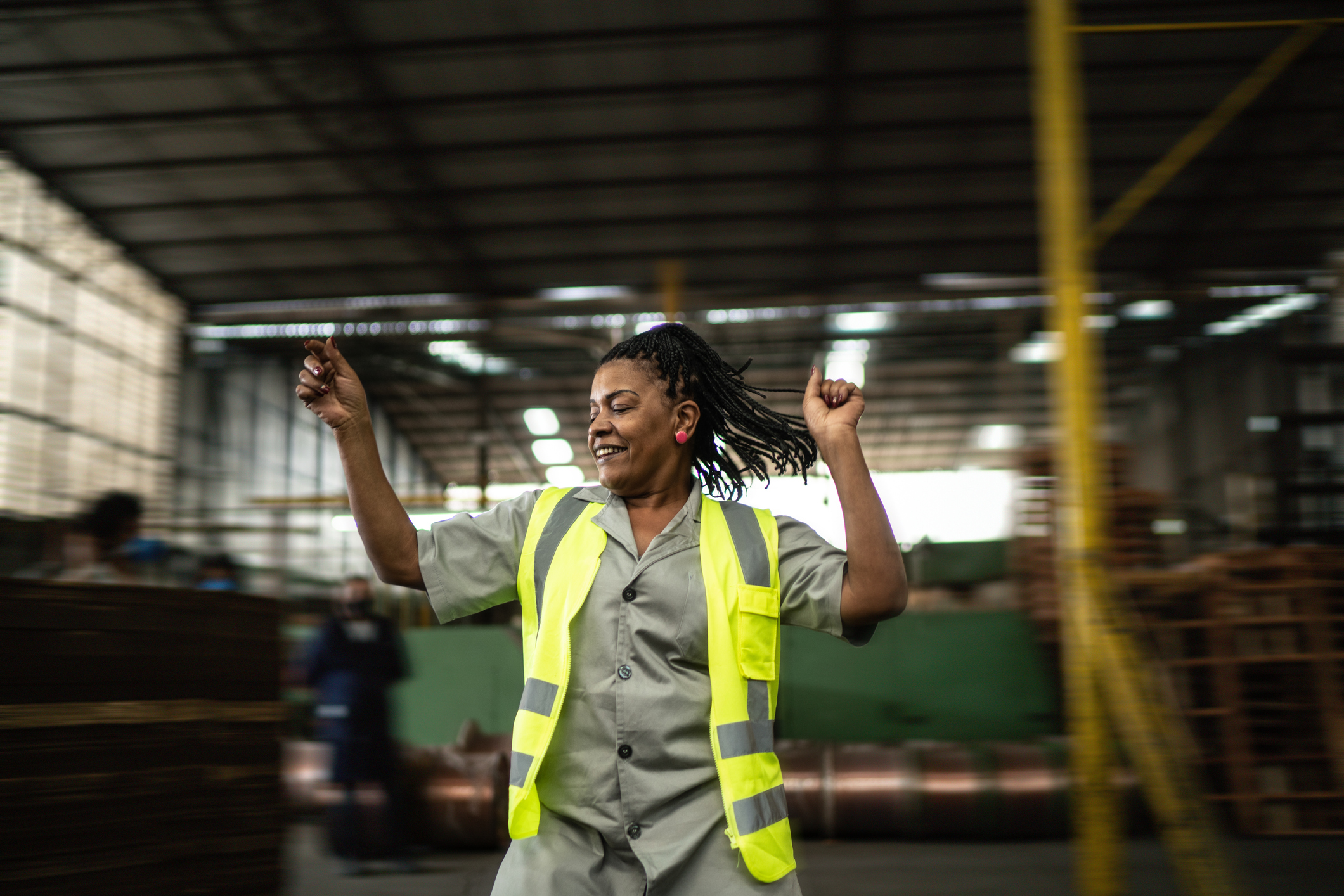 Happy mature woman dancing in a industry