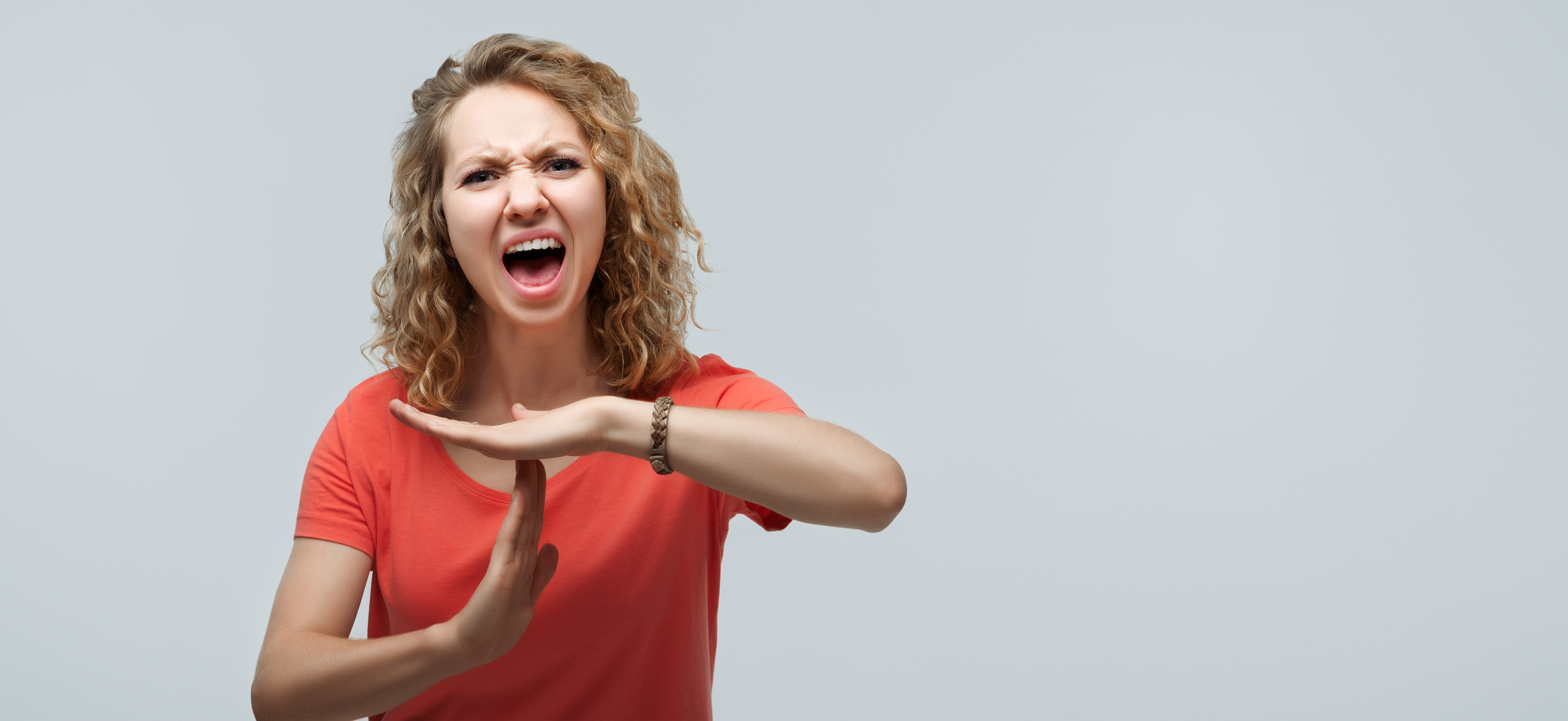 Pretty Young blonde woman doing time-out gesture with hands. Facial expression concept. Copy space