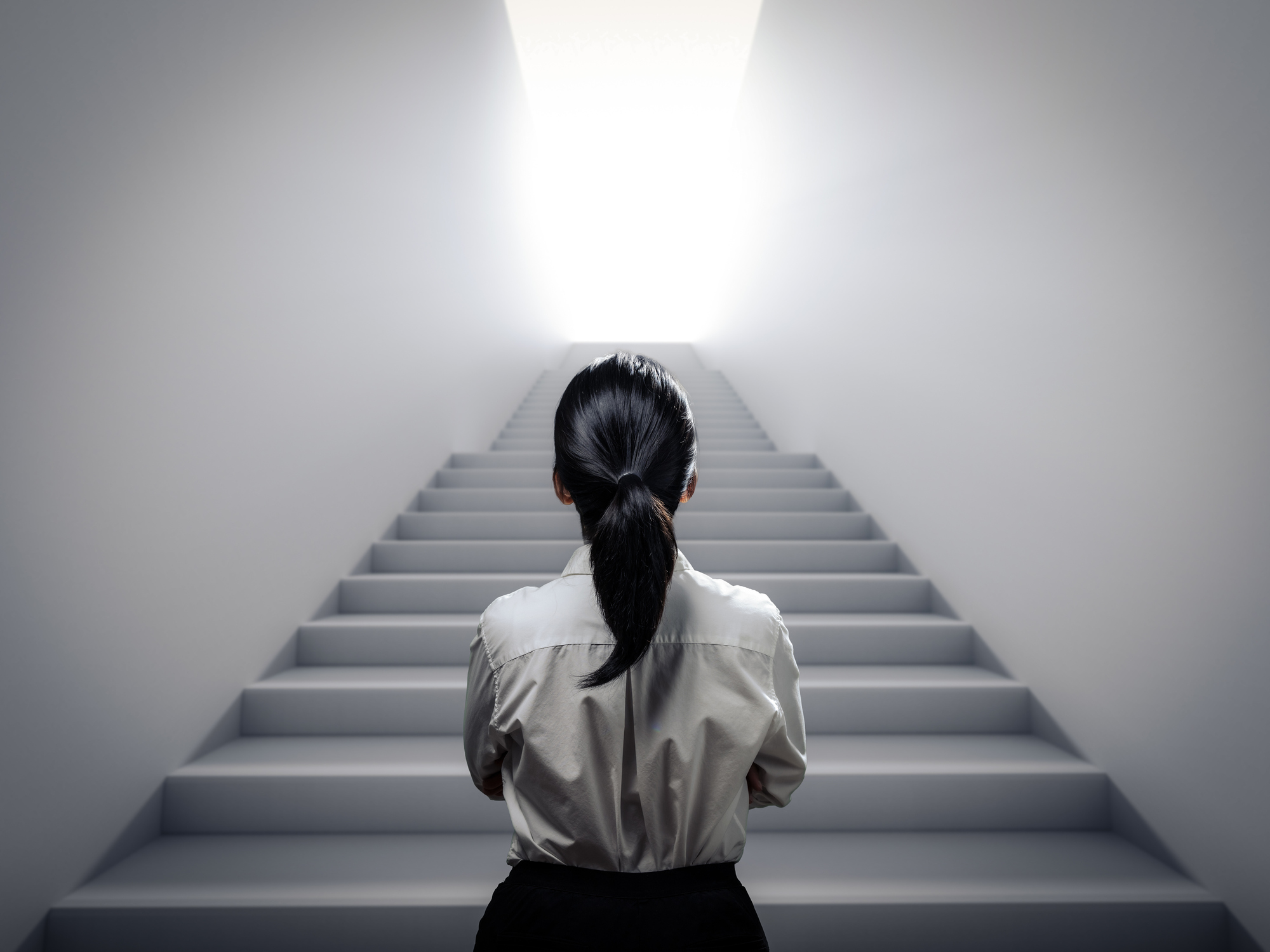 businesswoman standing at staircase