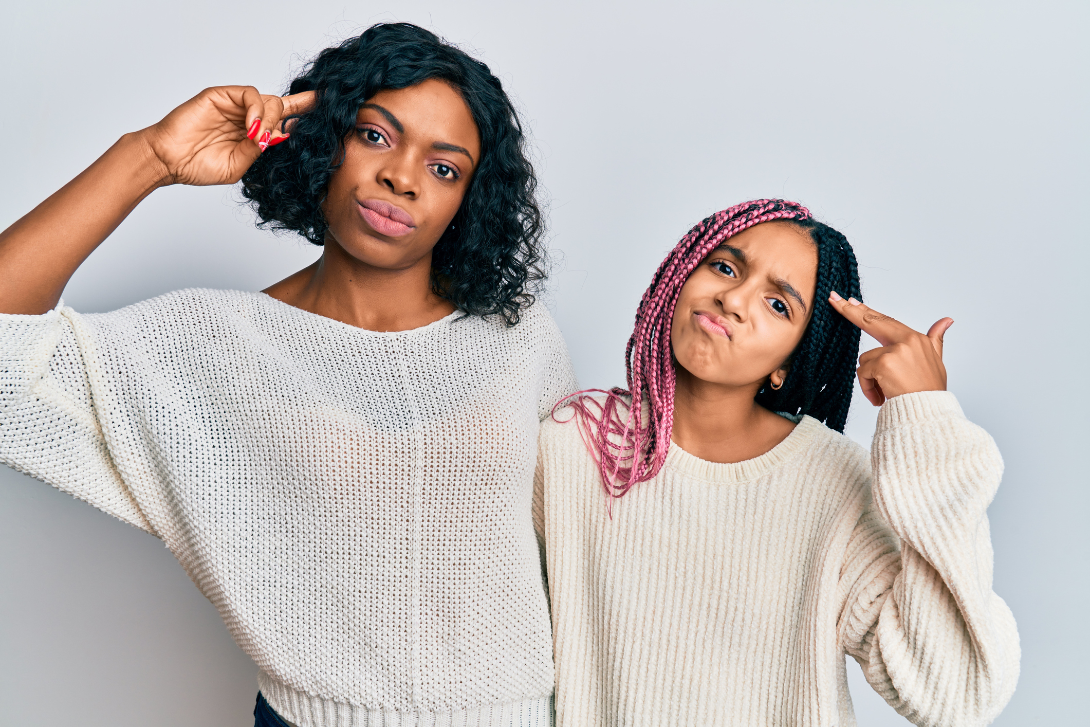 Beautiful african american mother and daughter wearing casual clothes and hugging shooting and killing oneself pointing hand and fingers to head like gun, suicide gesture.