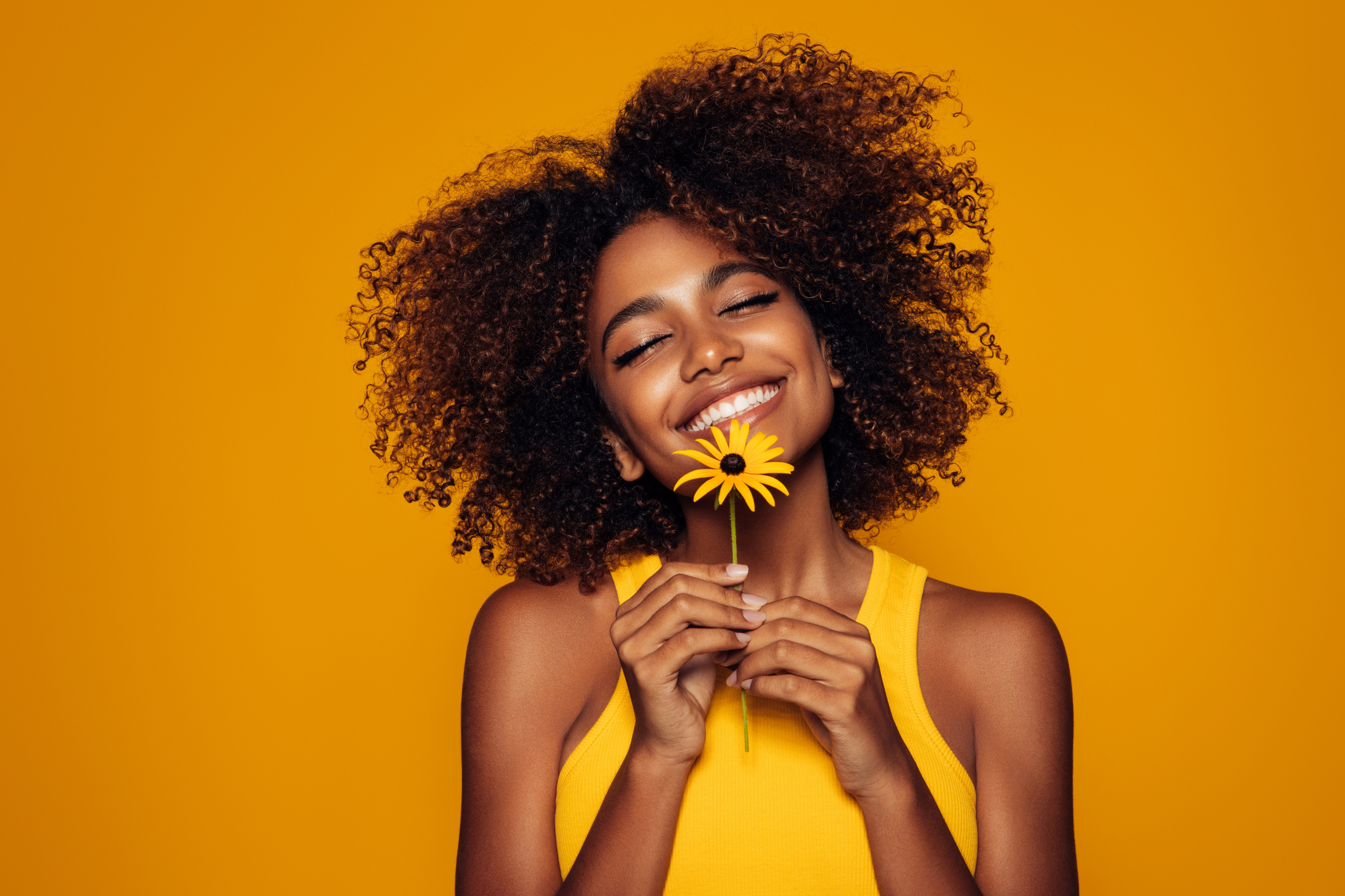 Beautiful afro woman with a flower