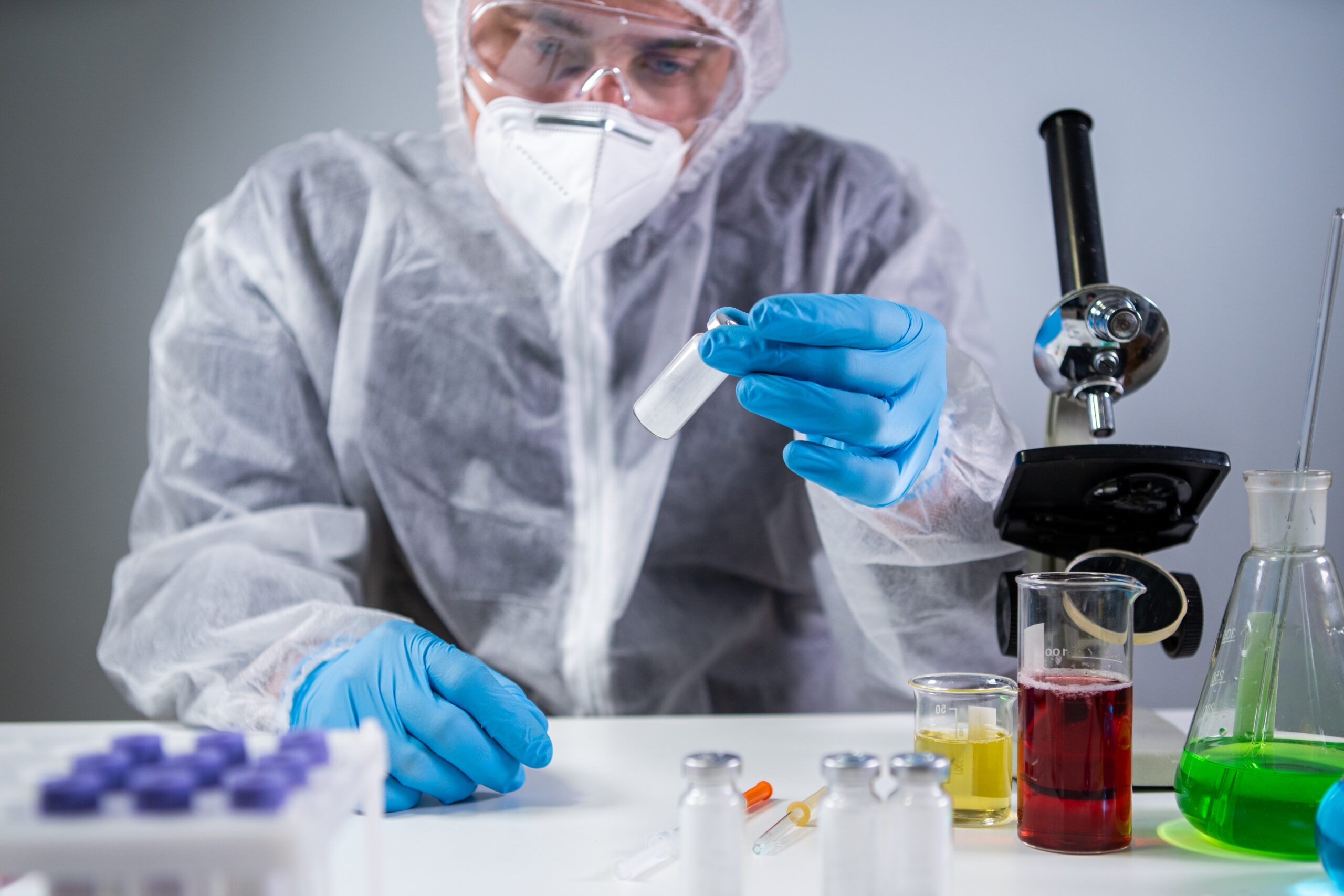 Exploring Covid 19 medicinee. Vaccine bottle for COVID-19 coronavirus in researcher hand. Medical doctor or laborant holding tube with nCoV Coronavirus vaccine for 2019-nCoV COVID virus