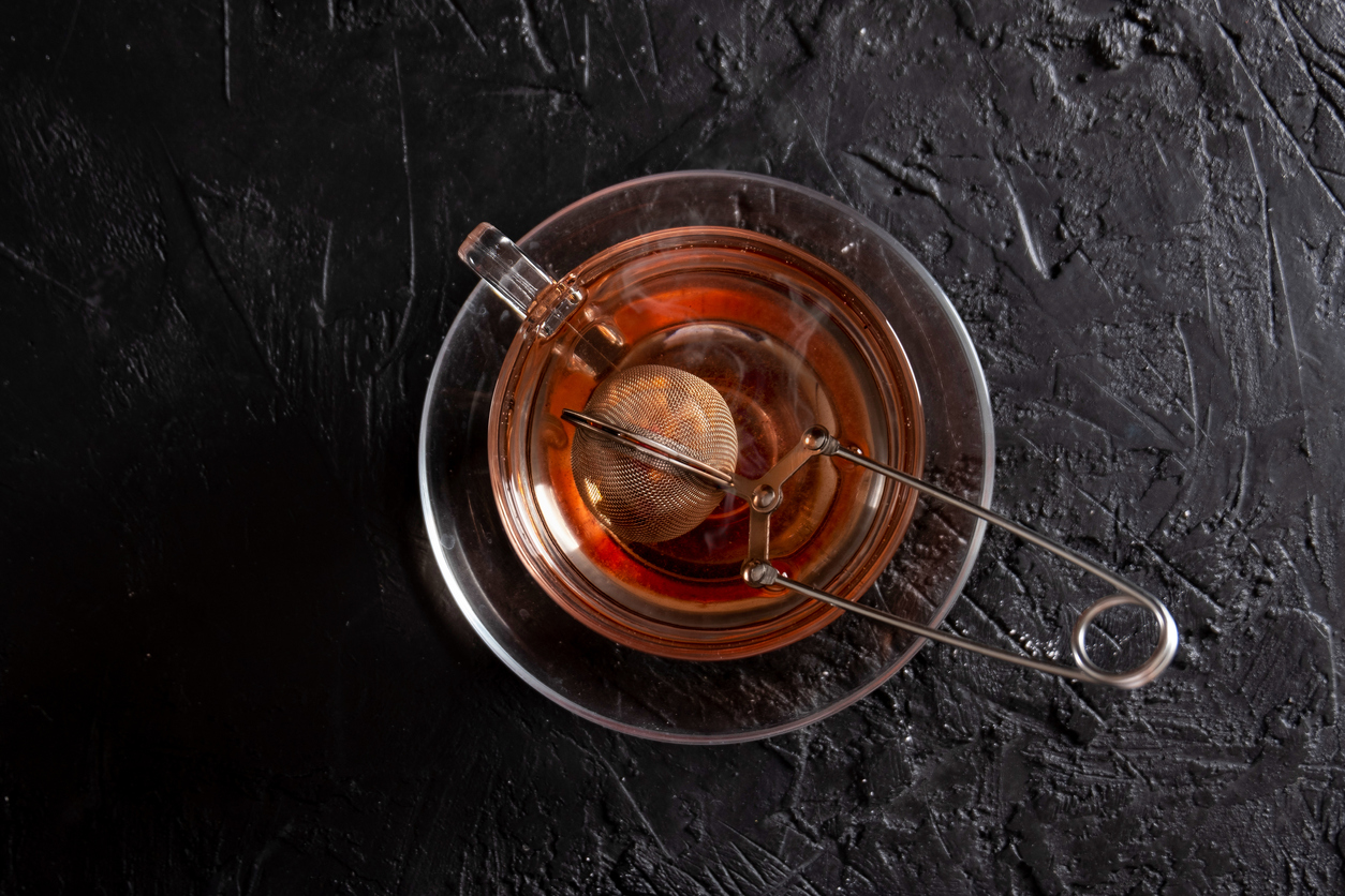 Hot Herbal Tea on the Black Background