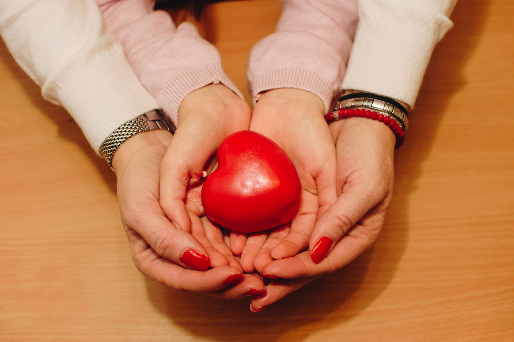 Hands holding red heart stock photo