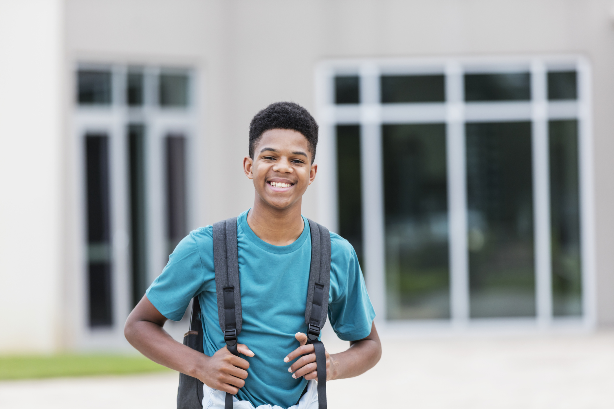 African-American teenager standing outside school