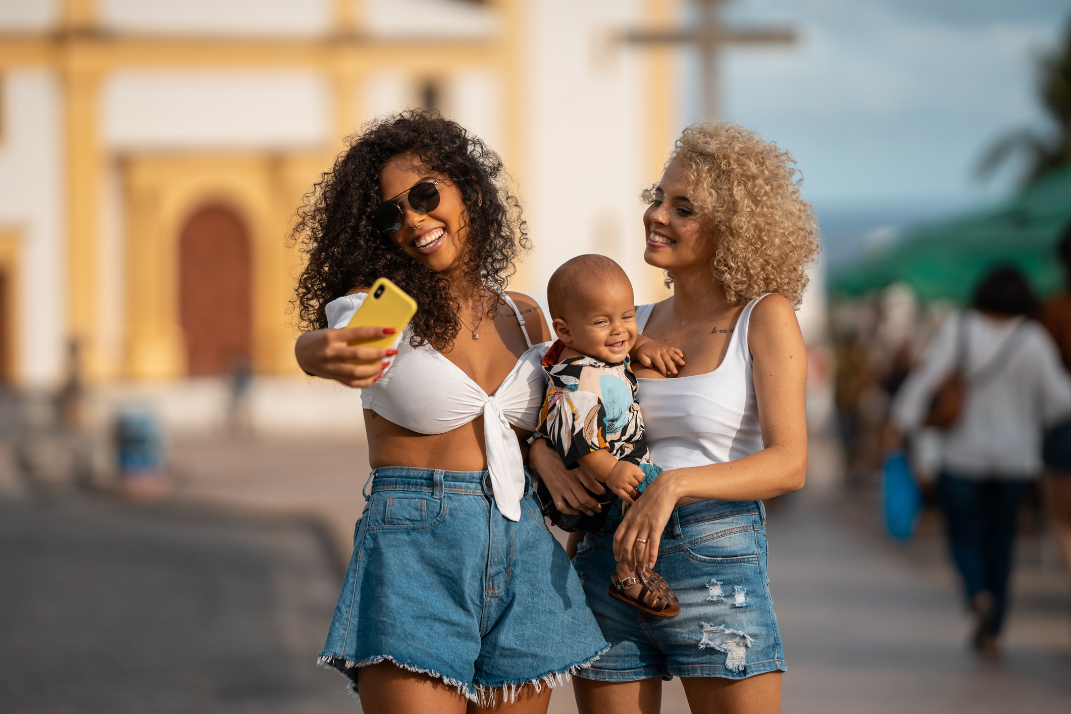 Women make selfie with baby on lap