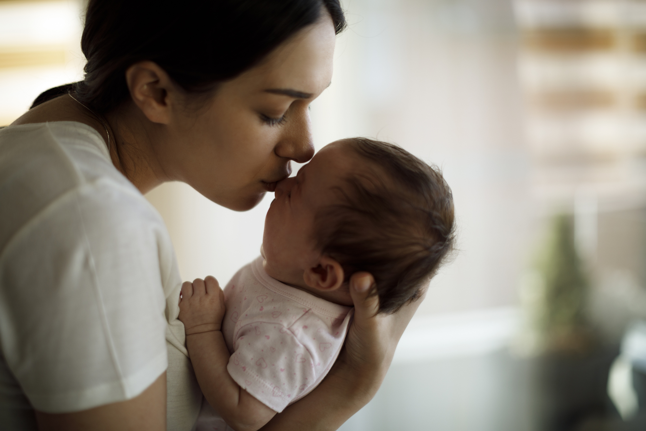 Mother kissing her crying baby