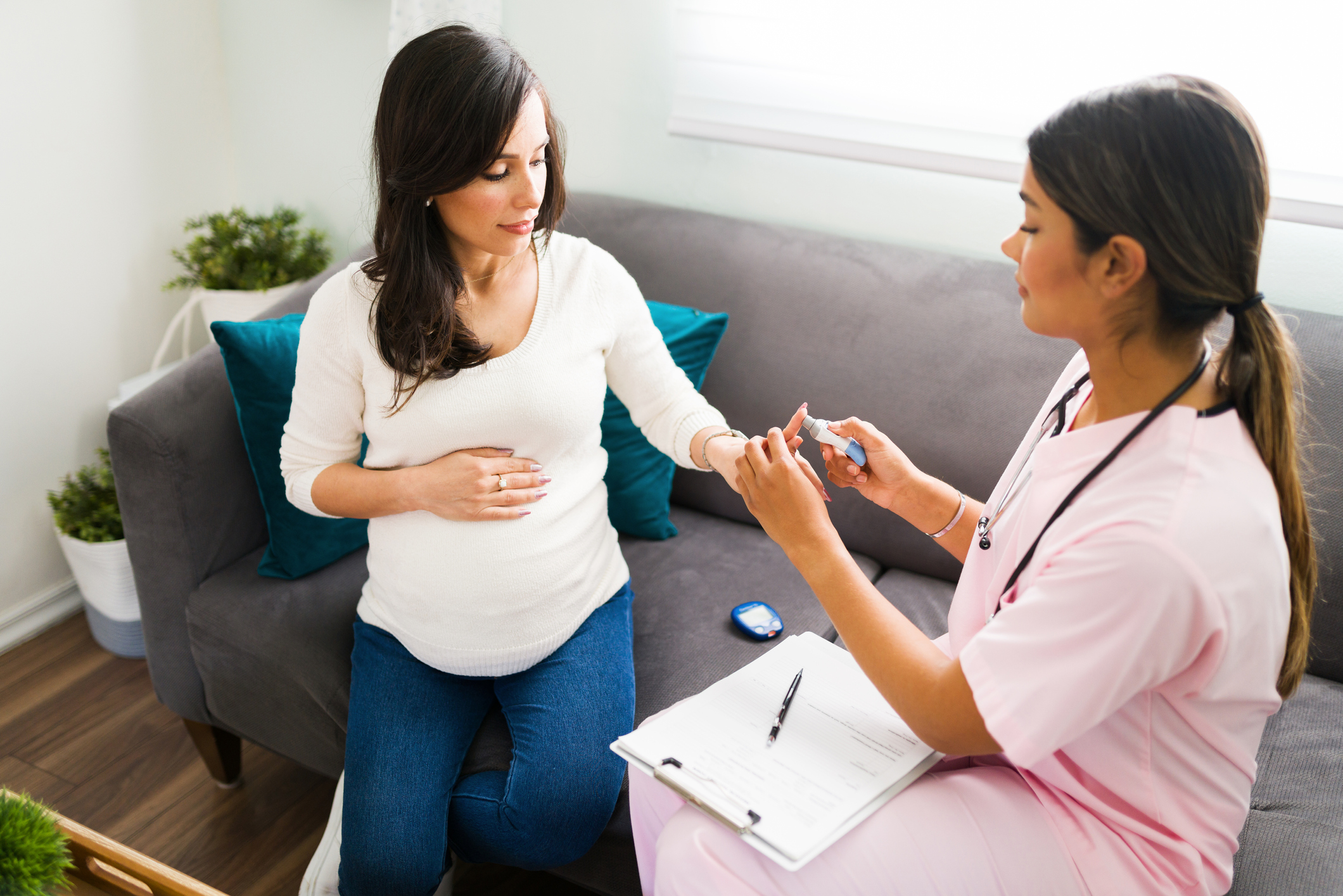 Nurse testing the blood sugar levels of a pregnant woman