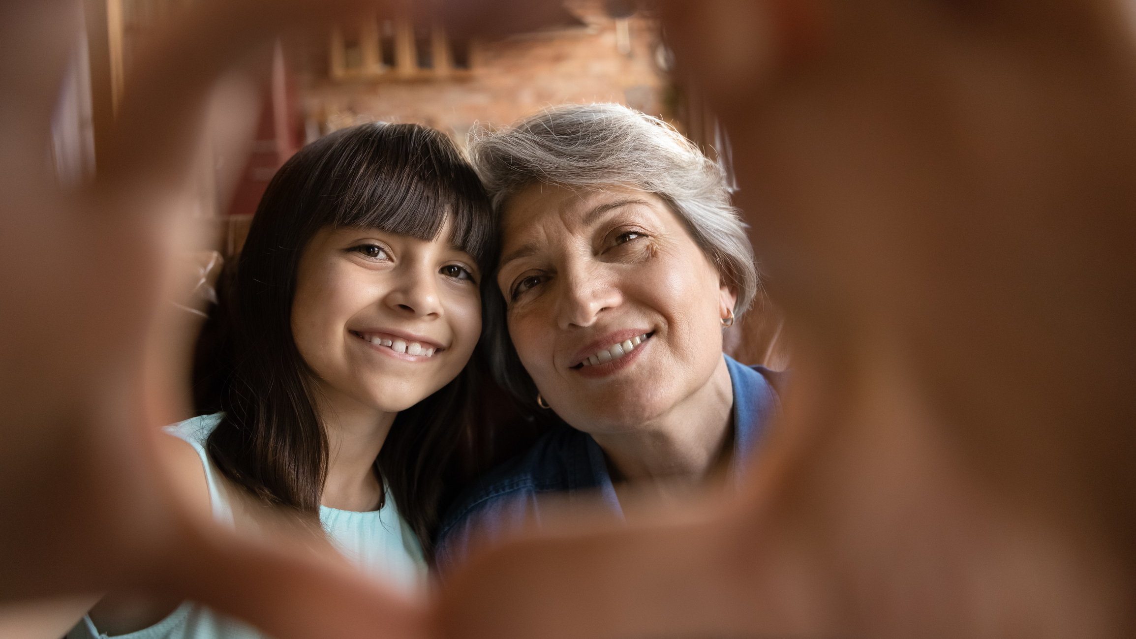 Portrait of happy Hispanic grandmother and little granddaughter