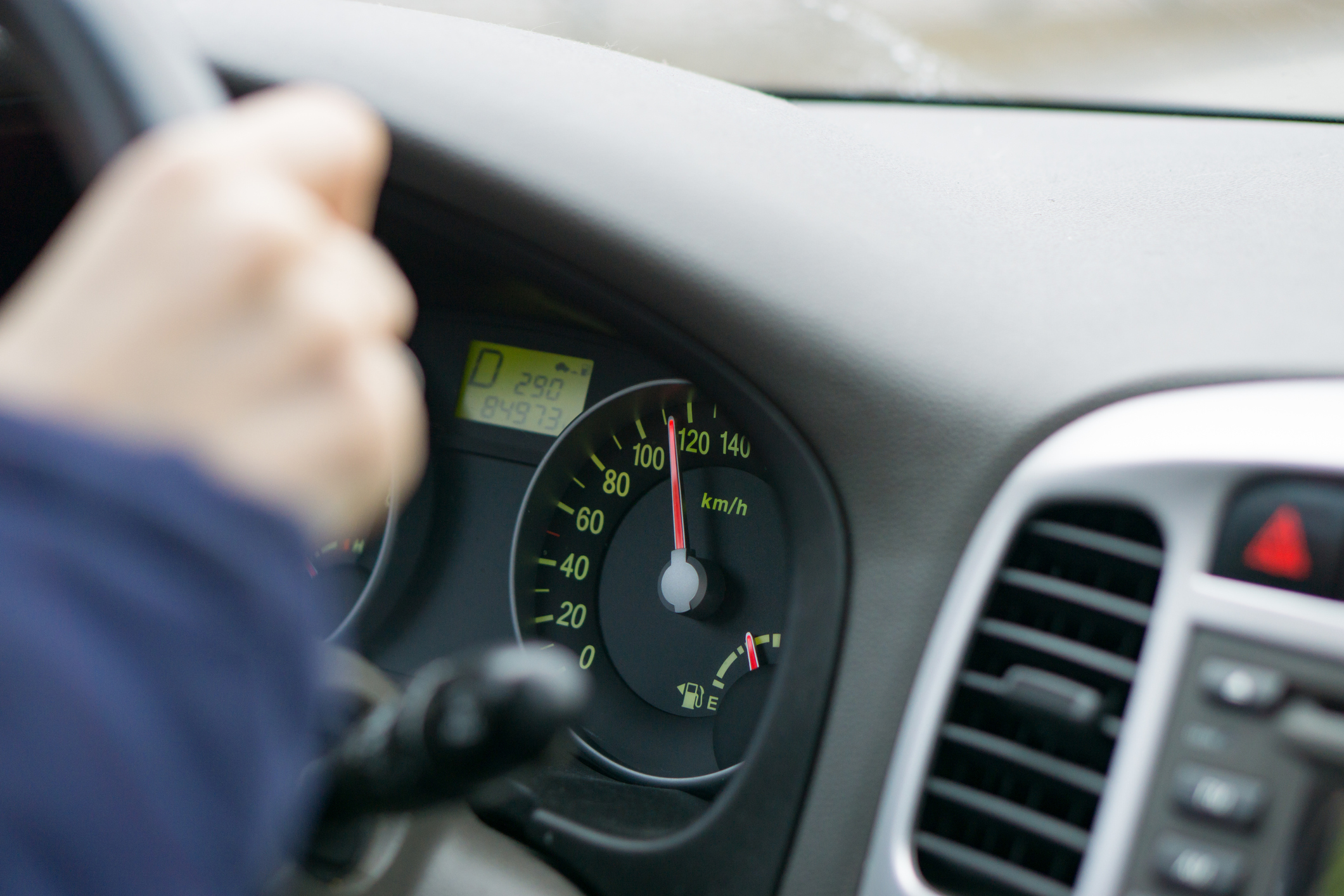 selective focus image of car interior. focus on speedometer