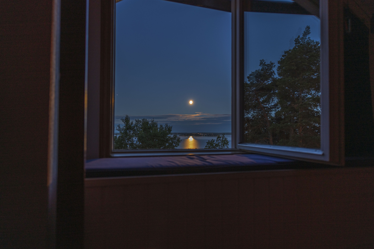 Gorgeous view of sunset trough open window. Sweden.