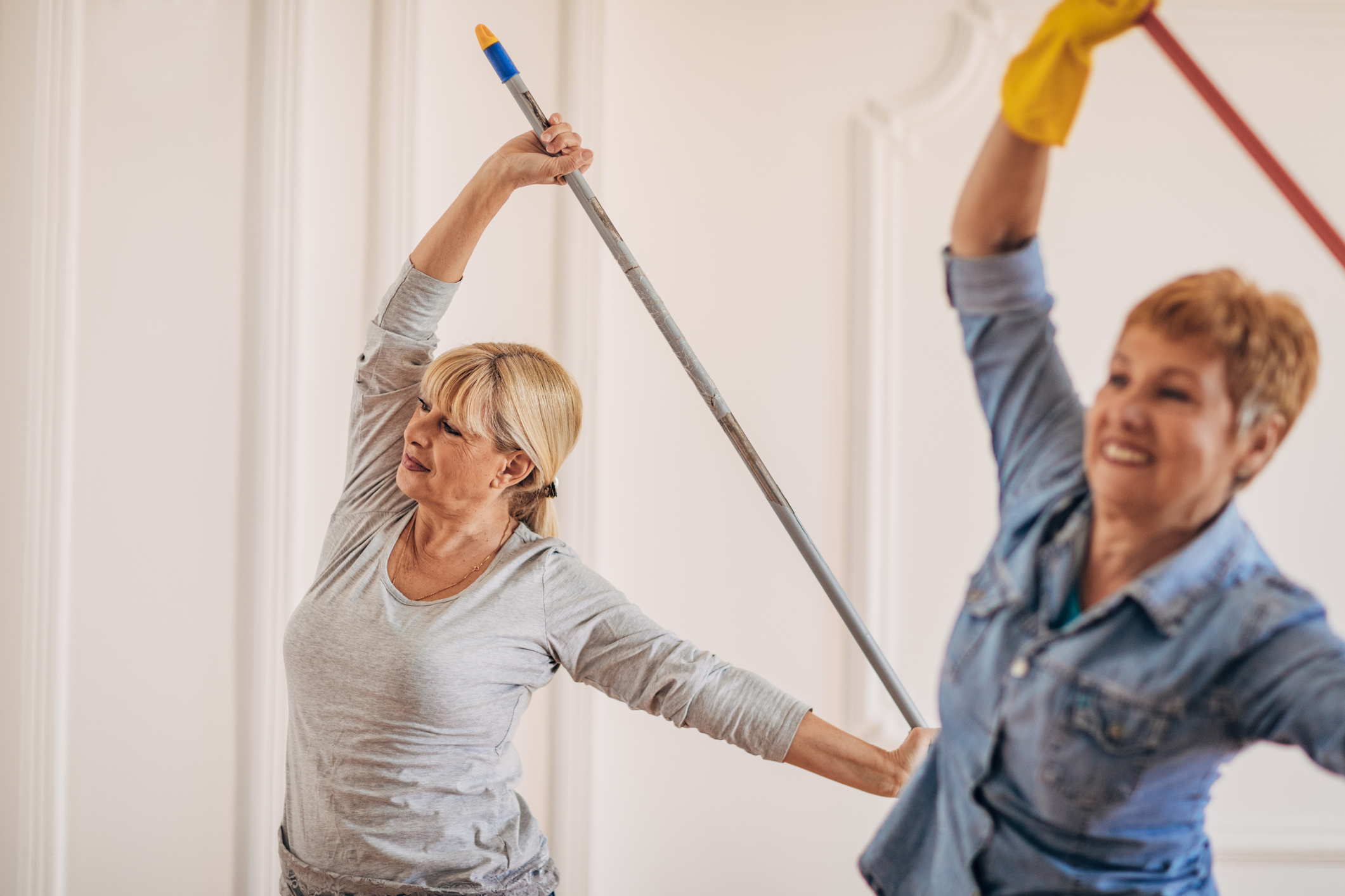 Female cleaners exercising while working