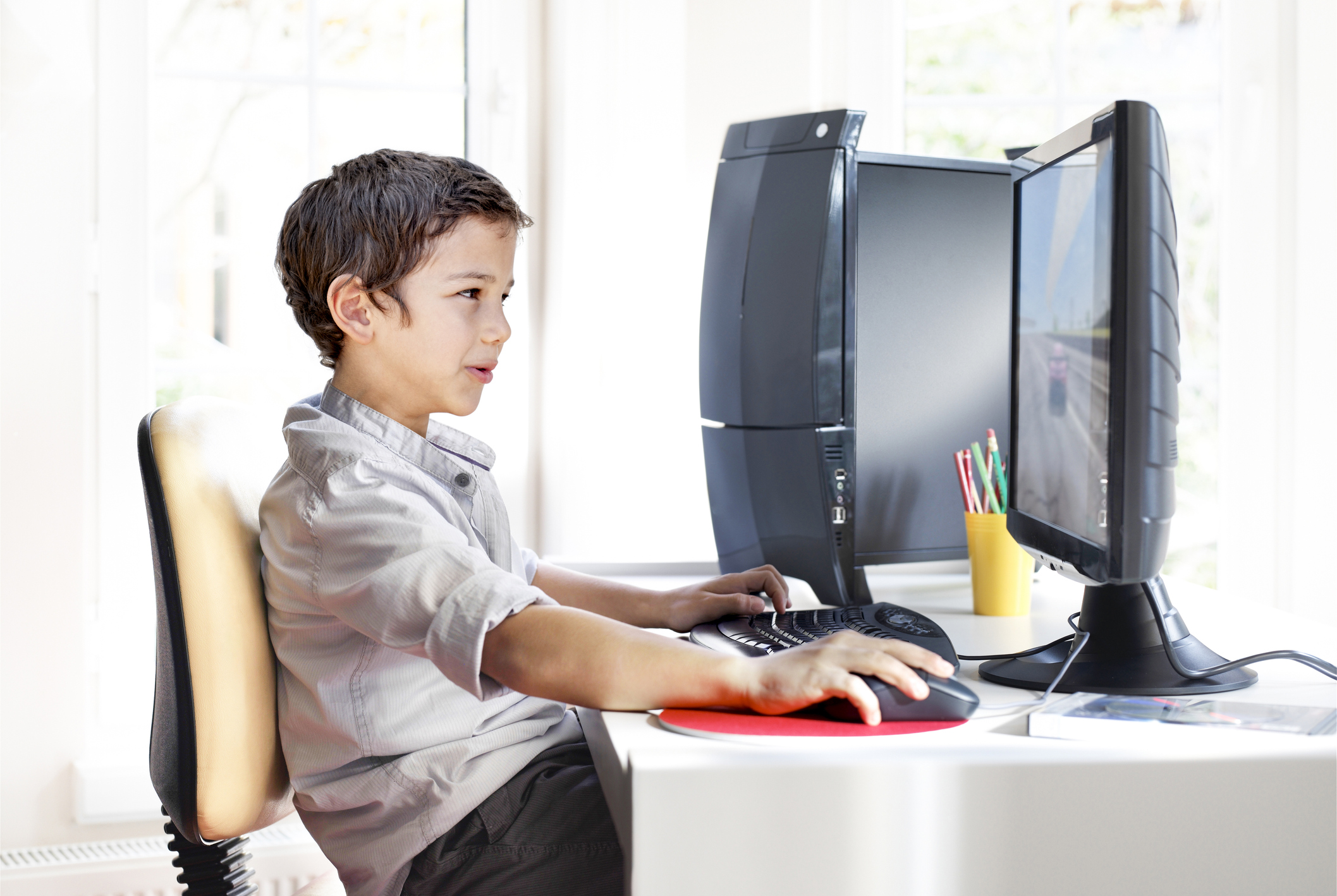 Boy playing game on desktop computer