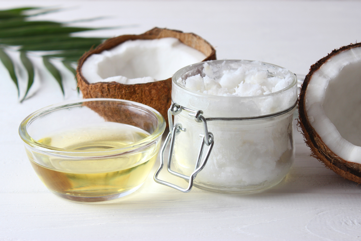 coconut oil and coconuts, palm branches close up