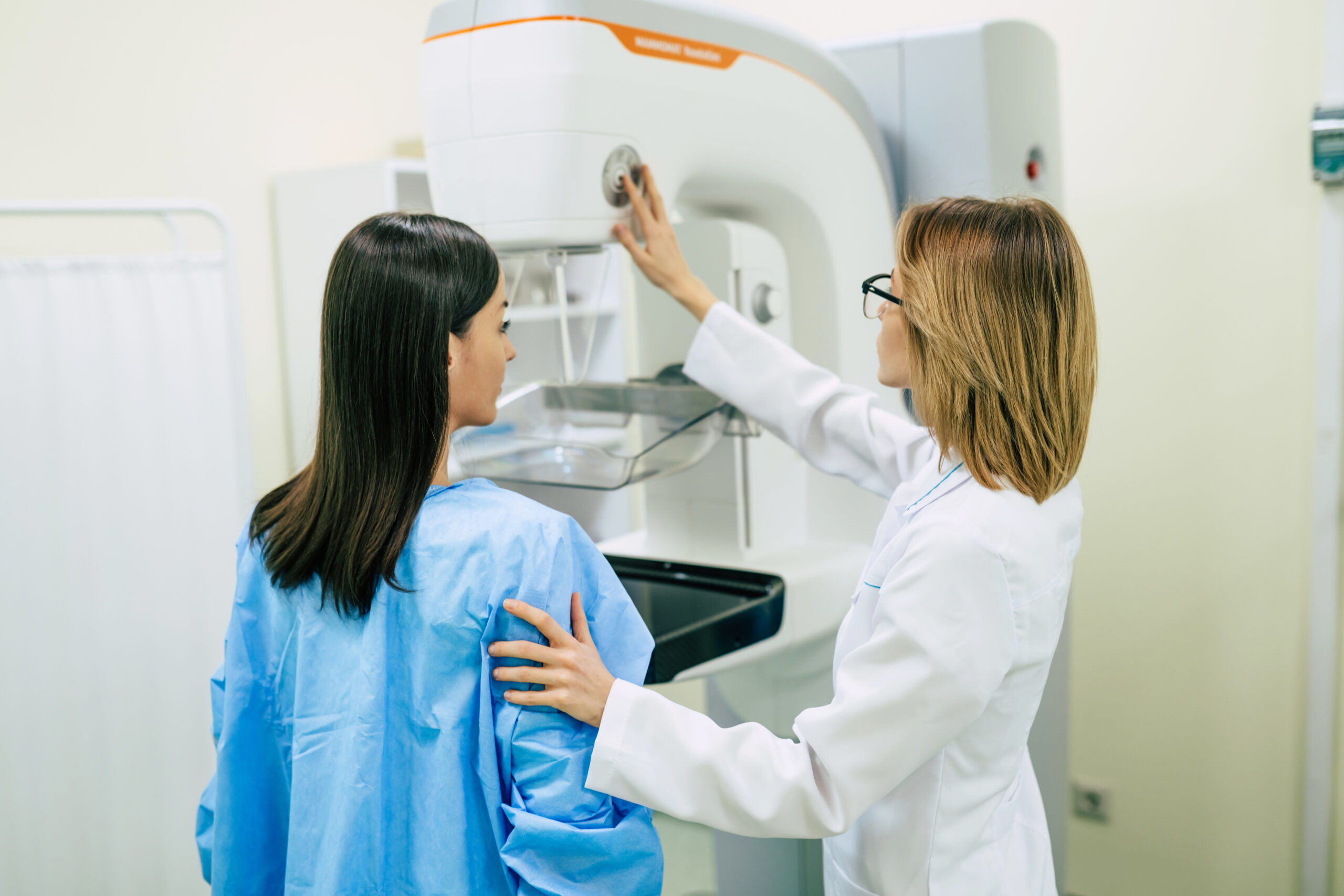 Young woman is having mammography examination at the hospital or private clinic with a professional female doctor.