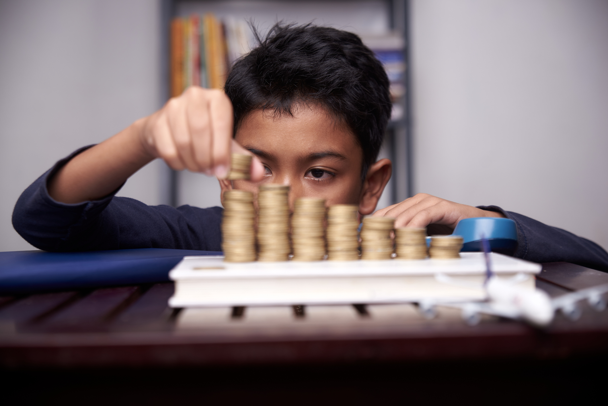 Asian boy saving money for education