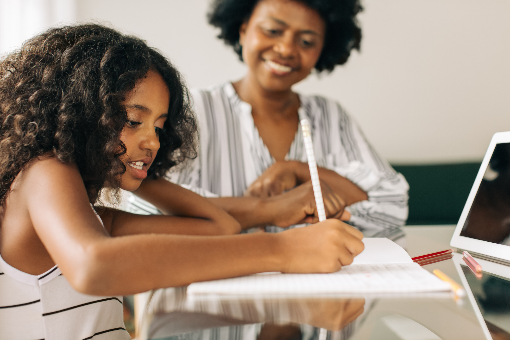 Girl doing her homework with grandmother