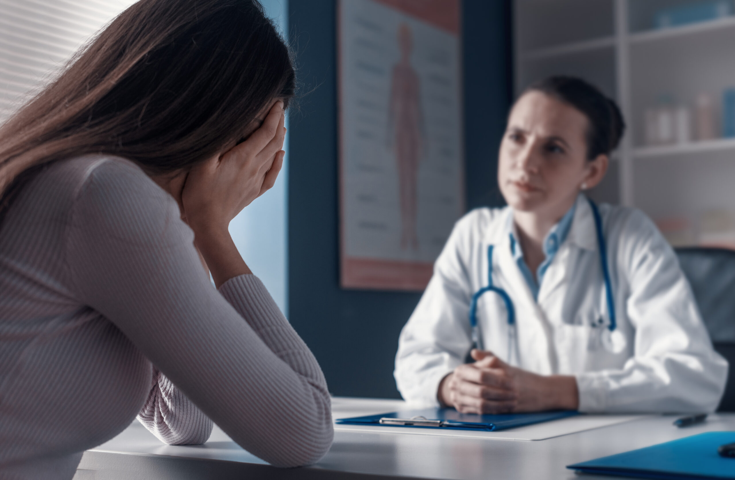 Doctor assisting a crying patient in the office