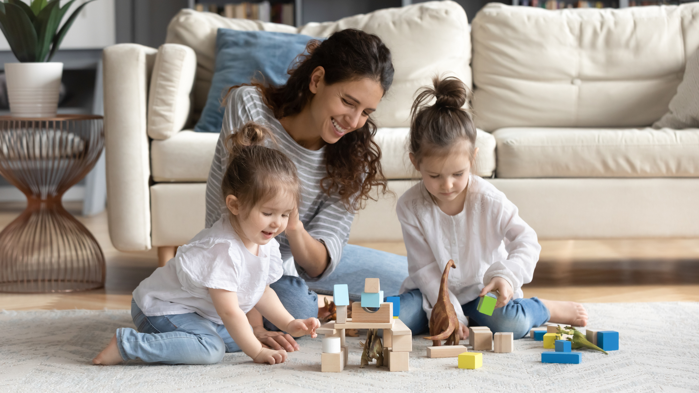 Caring happy mom play with little daughters