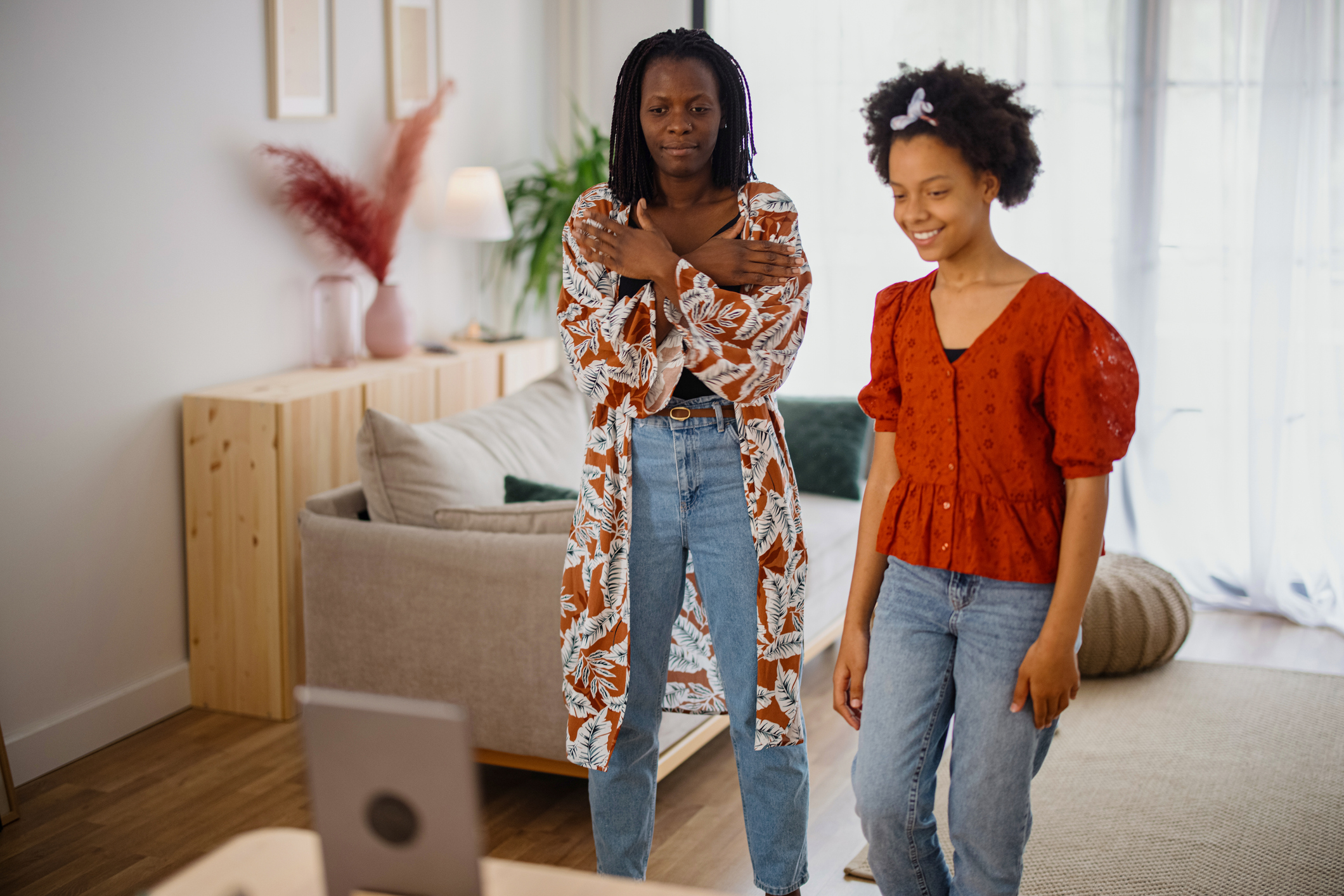 Mother and daughter recording a dance video at home