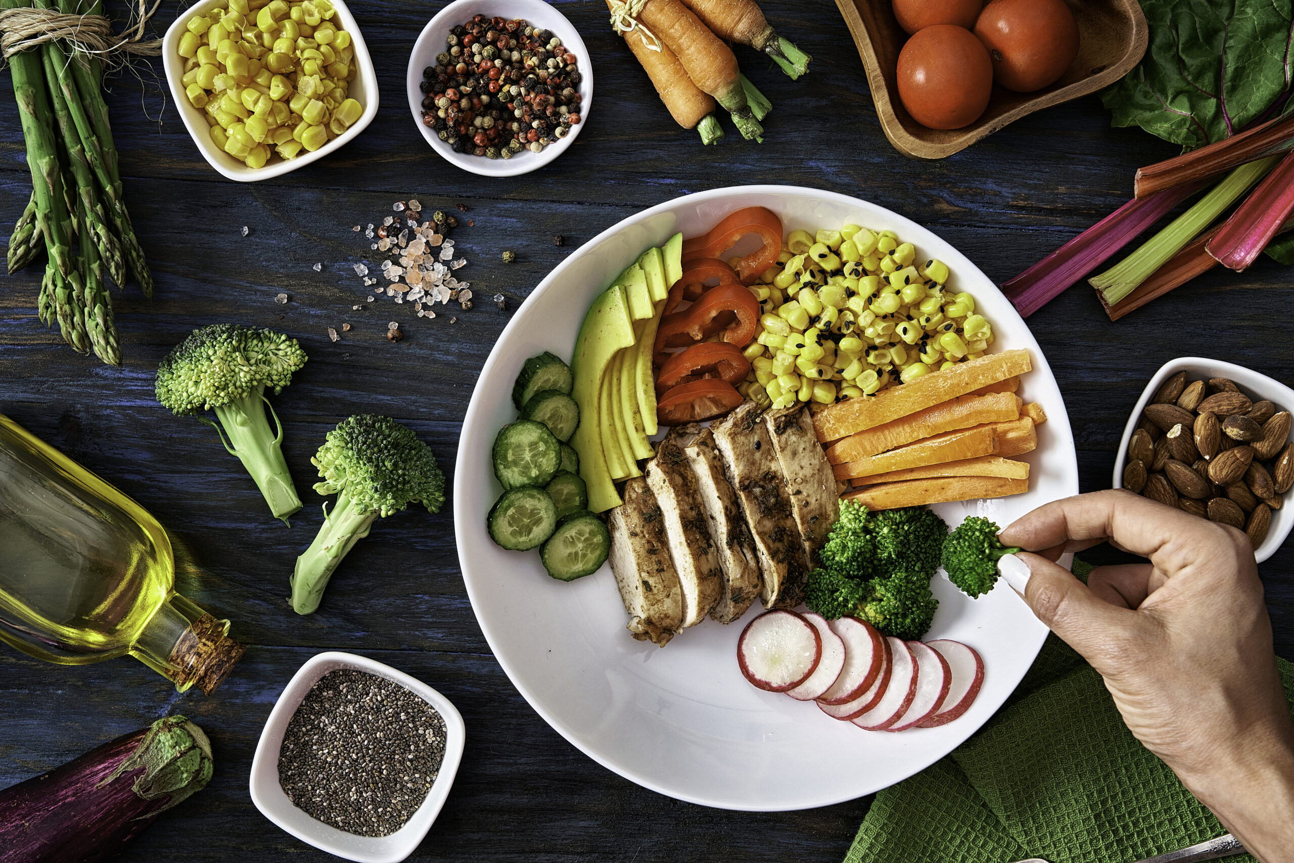 Healthy eating and diet concepts. Top view of woman hands preparing a healthy fresh salad in a bowl.