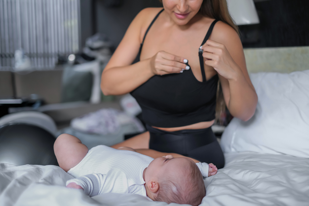 Mother Preparing To Breastfeed Her Baby