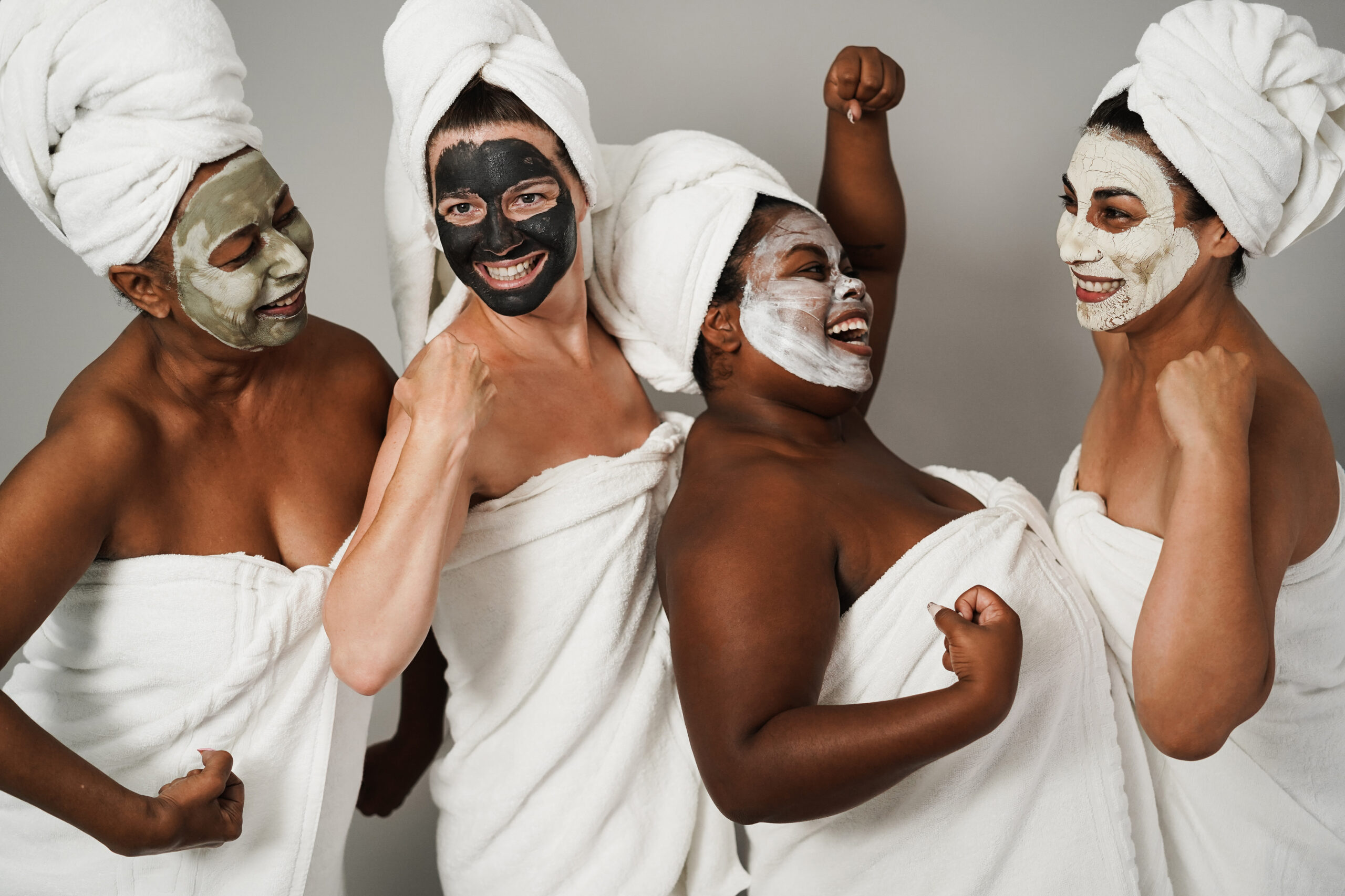 Multigenerational women having fun wearing face beauty mask - Skin care therapy and female power - Main focus on caucasian woman face